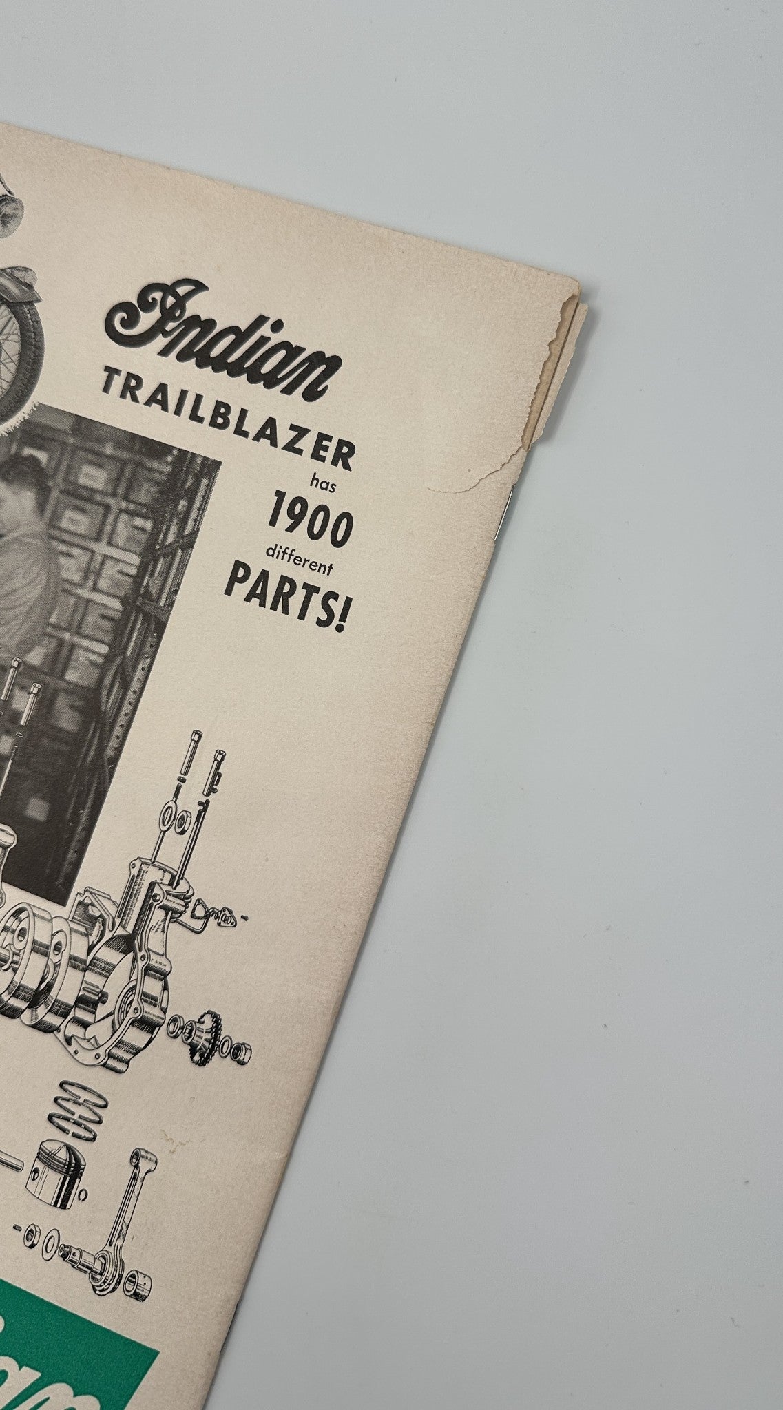 Close-up image of Cycle Magazine October 1955 showing wear on the cover, highlighting an advertisement for Indian motorcycles and their extensive parts availability.