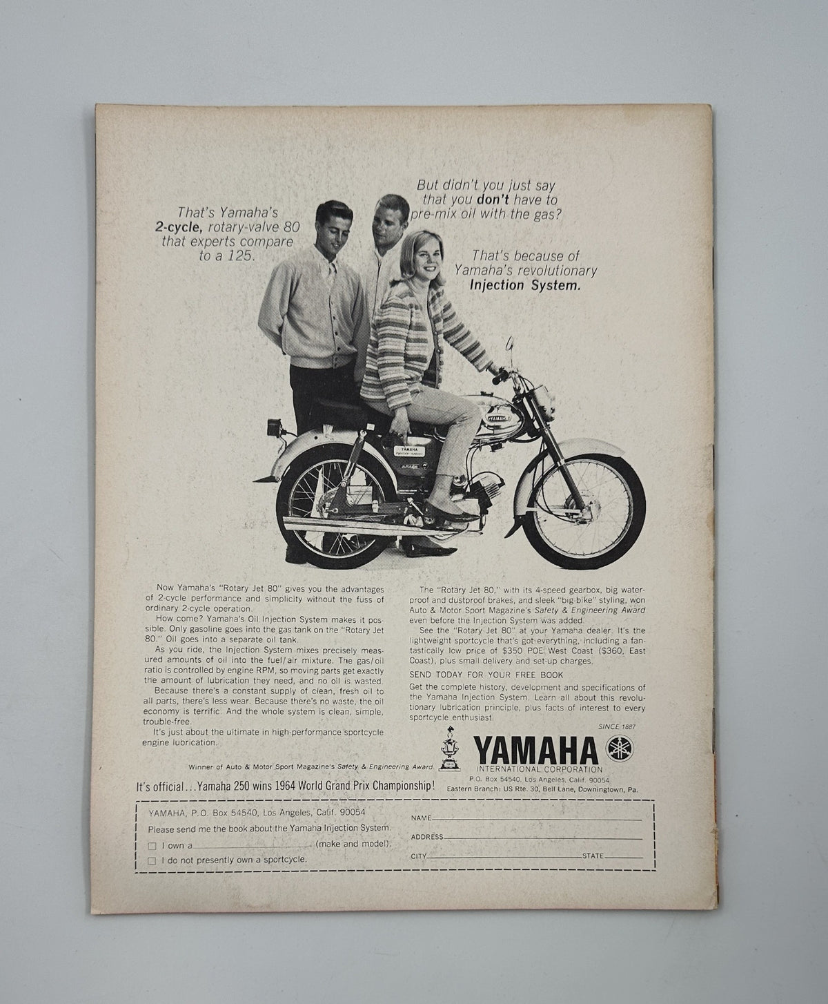 Advertisement from Cycle Magazine December 1964 for Yamaha, showcasing a youth on a motorcycle, promoting Yamaha's revolutionary Injection System.