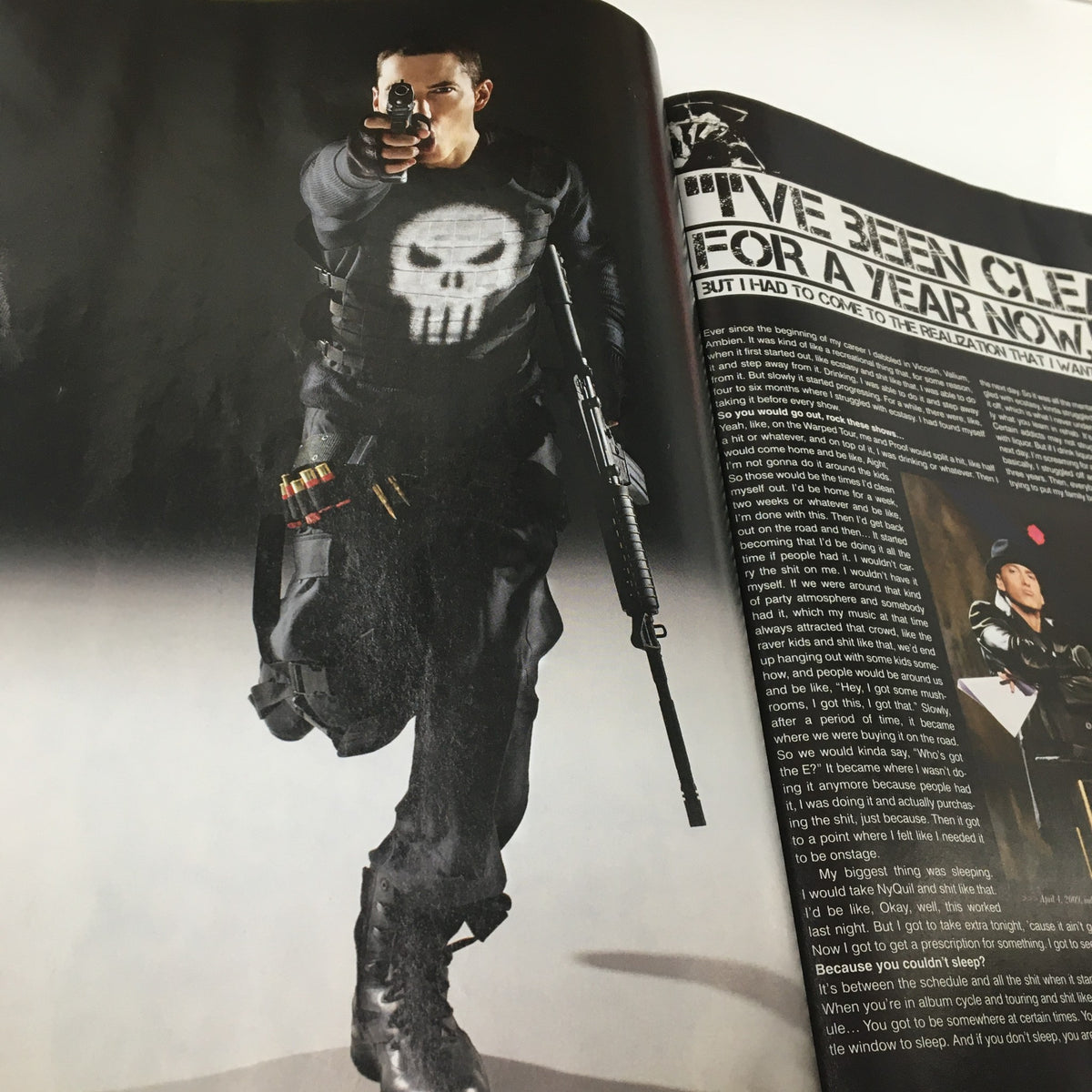Dramatic photo from XXL Magazine June 2009 showcasing a character posed with weapons, representing The Punisher in the 'Vengeance is Eminem and The Punisher' feature.