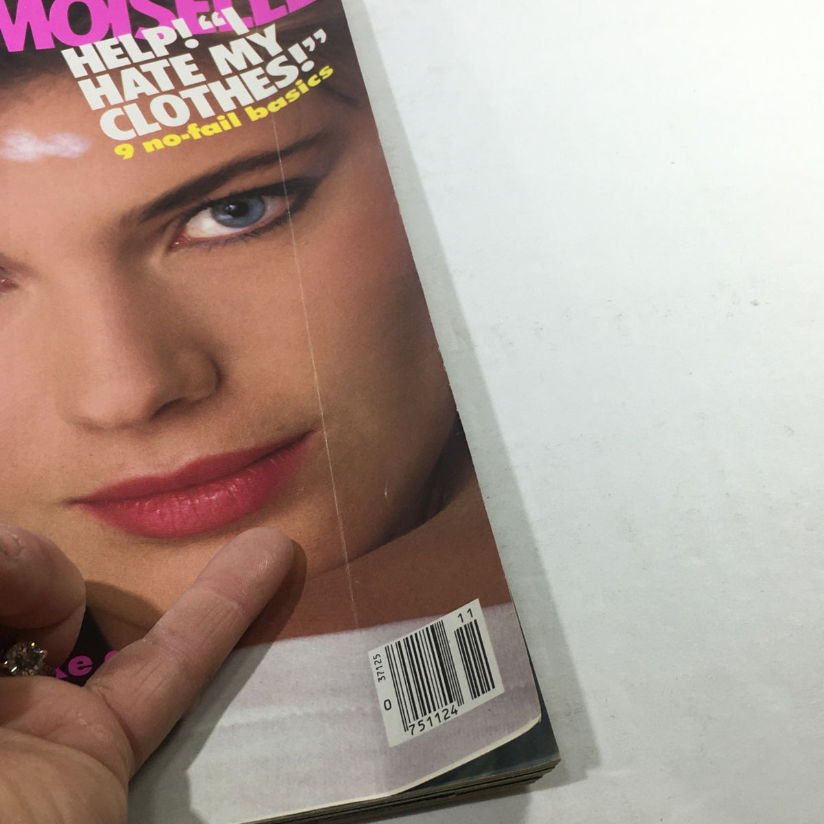 Side view of the VTG Mademoiselle Magazine: November 1983, highlighting the magazine's colorful cover design and barcode, showcasing its vintage character.