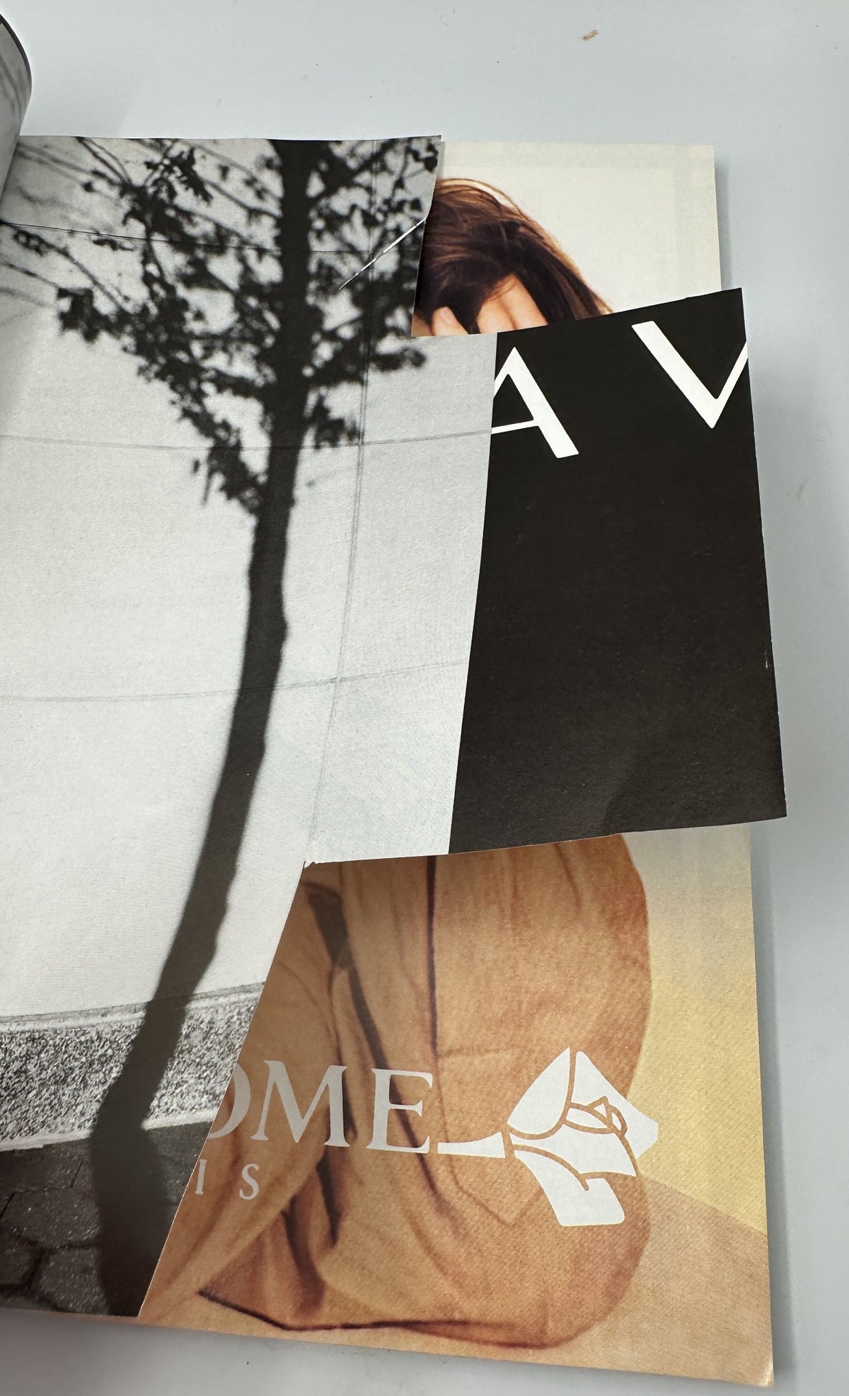 Close-up of a page from Vanity Fair Magazine March 1994 showing overlapping pages and cut-outs, reflecting the magazine's well-loved condition.