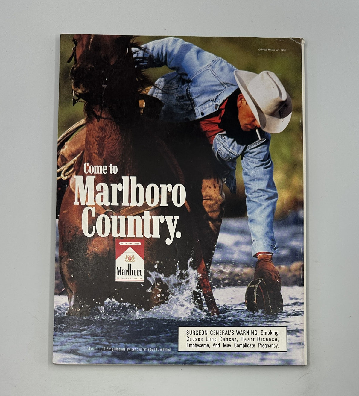 The cover of Vanity Fair Magazine March 1994 featuring an advertisement for Marlboro cigarettes with a cowboy on horseback in a natural rural setting, emphasizing the call to 'Come to Marlboro Country'. This historic issue discusses notable personalities including Marla and Donald Trump.