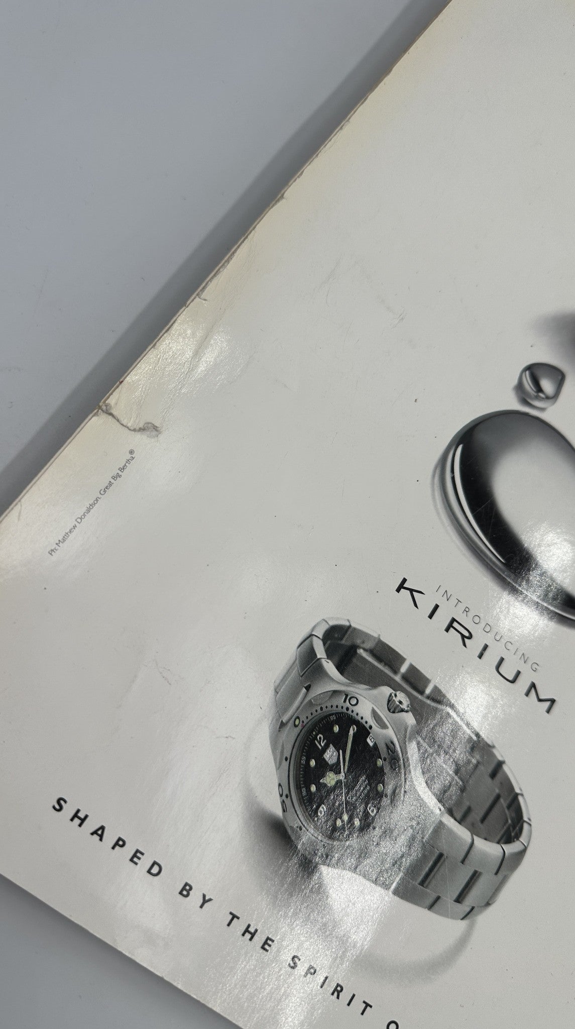 A close-up of the cover of Wallpaper Magazine January/February 1998 showing a corner crease, indicating moderate signs of age, with an advertisement for TAG Heuer Kirium watch.