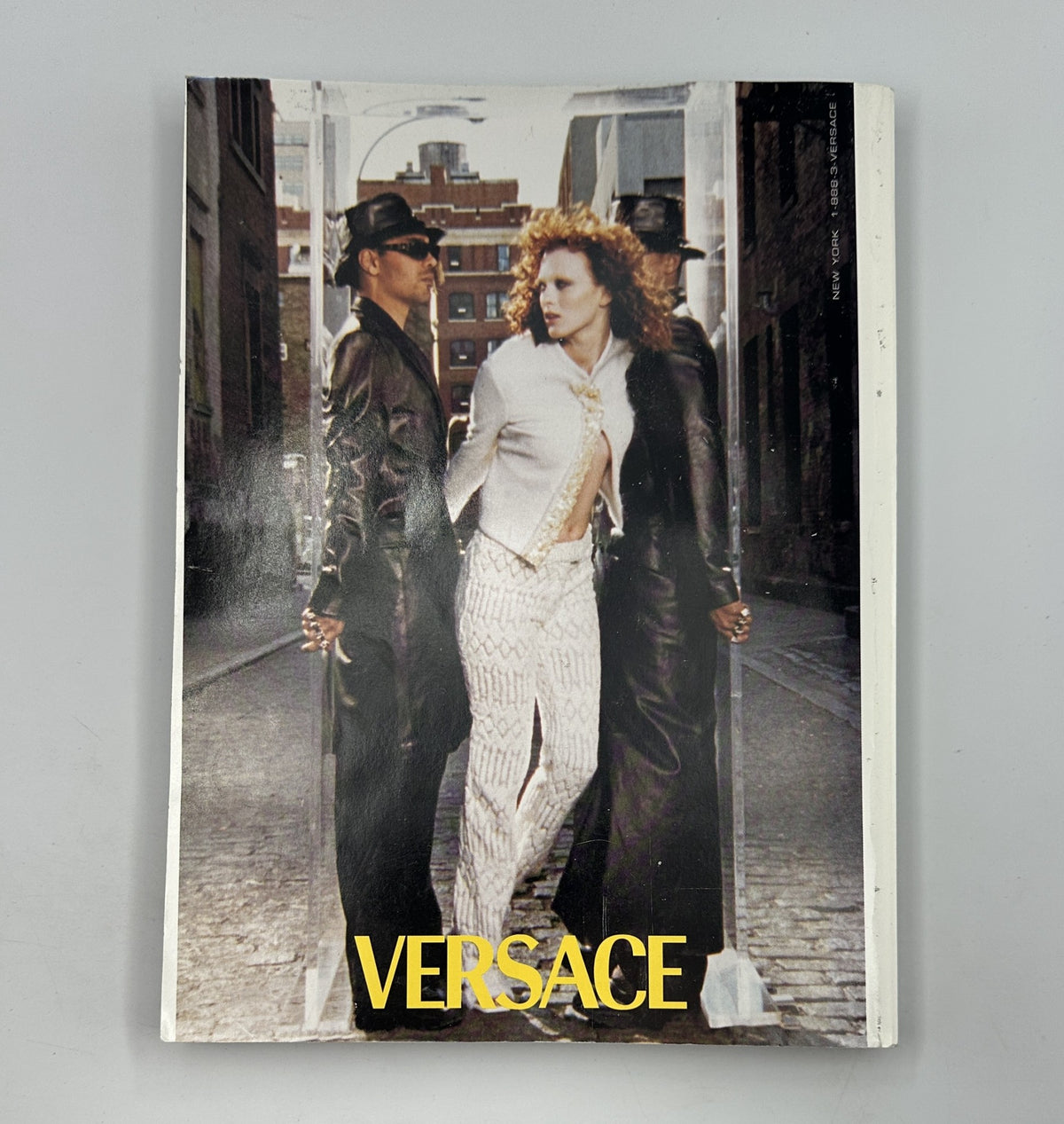Cover page of Vogue Magazine November 1999 featuring a bold Versace advertisement showcasing a model styled in contemporary, chic fashion, representative of iconic high fashion.