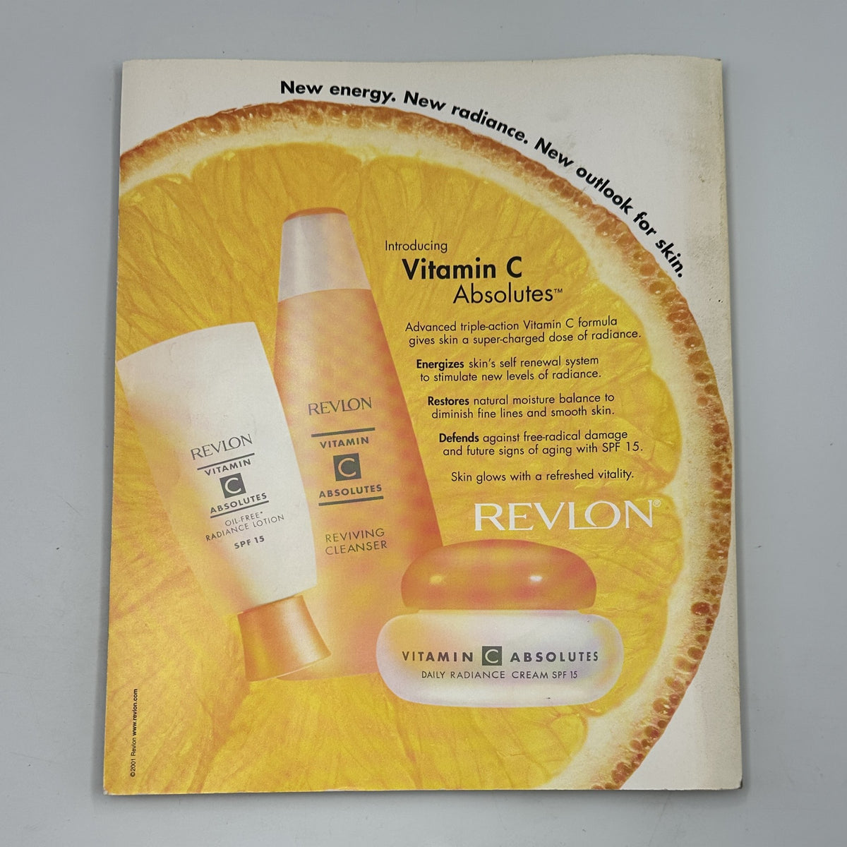 Introducing Vitamin C Absolutes by Revlon with bright packaging showcasing skincare products including a cleanser and cream, promoting skin radiance and renewal. Featured in Martha Stewart Living Magazine August 2001, highlighting hydrangeas and batik drinks.
