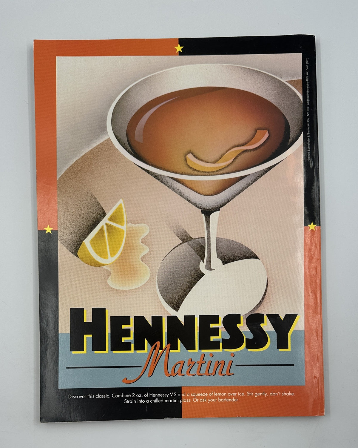 Vintage advertisement for Hennessy Martini, showcasing a classic drink illustration with vibrant graphics against a colorful background. Featured in the pages of a 1996 issue of Vanity Fair Magazine.