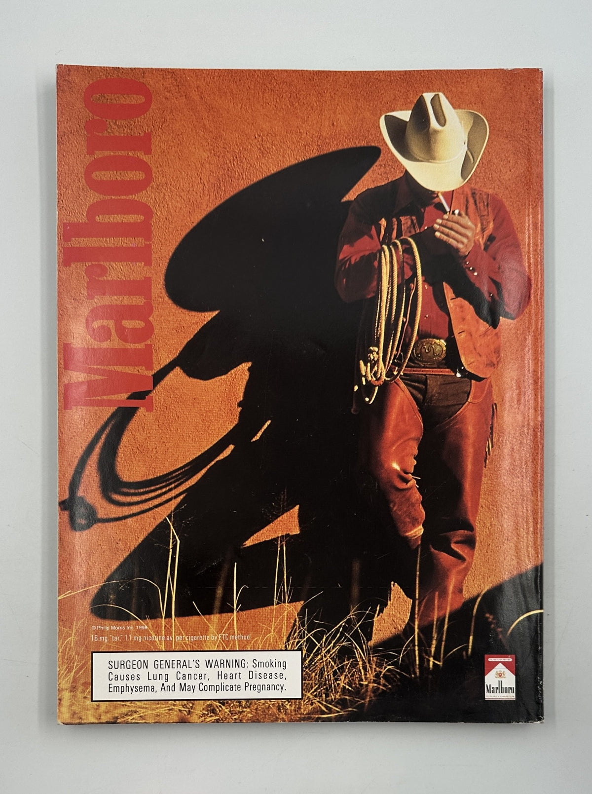 Cover of Marlboro Magazine featuring a cowboy with a lasso, reflecting the rugged American West, alongside a Surgeon General's Warning about smoking.