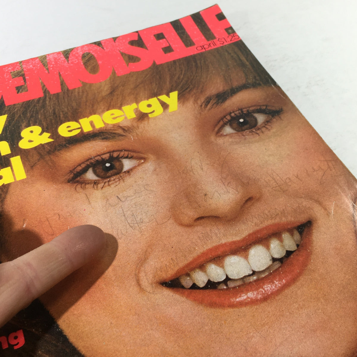 Detail view of the VTG Mademoiselle Magazine Cover from April 1977, focusing on Bonnie Lysohir's facial features and the unique characteristics of the historical magazine.