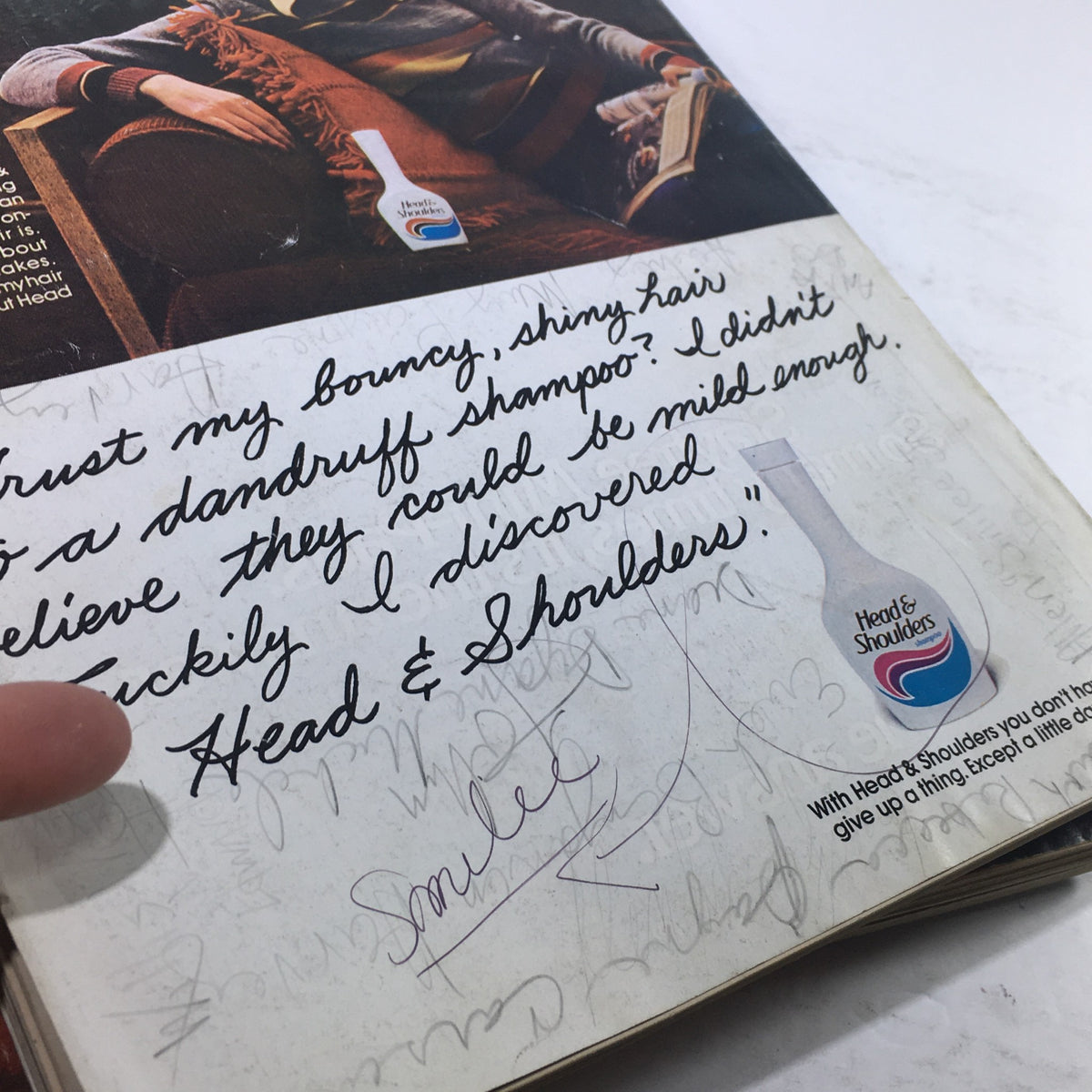 Close-up view of a vintage Mademoiselle Magazine page featuring a testimonial for Head & Shoulders shampoo, emphasizing its effectiveness for dandruff while preserving shiny hair. April 1977 issue with Bonnie Lysohir cover.