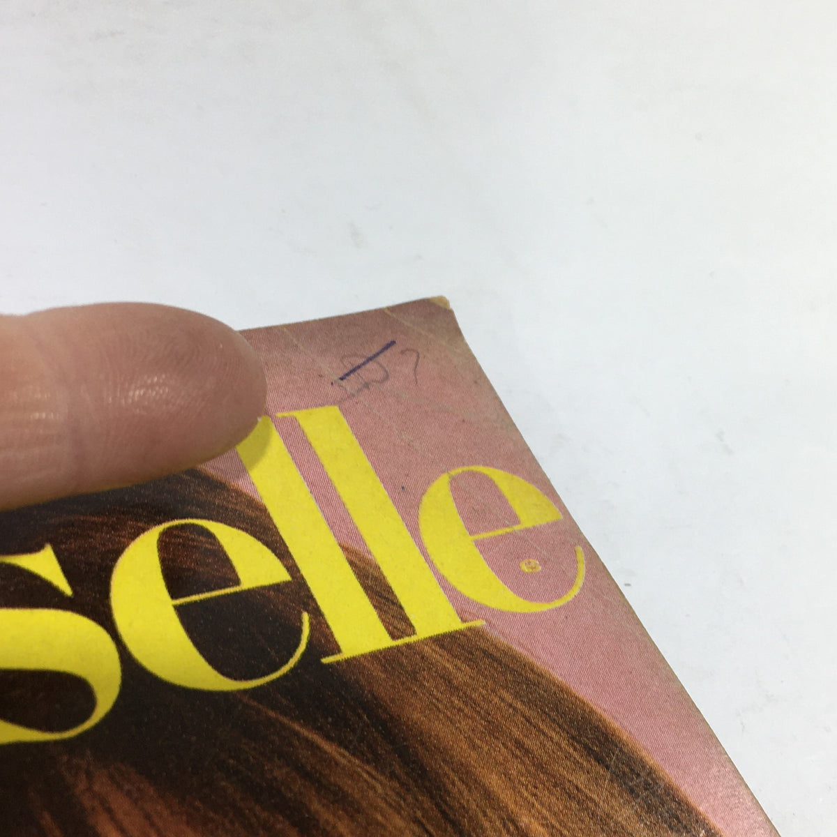 Close-up of the top corner of the Vintage Mademoiselle Magazine: March 1967 featuring Lucy Angle, showcasing the magazine title and minor wear on the cover.
