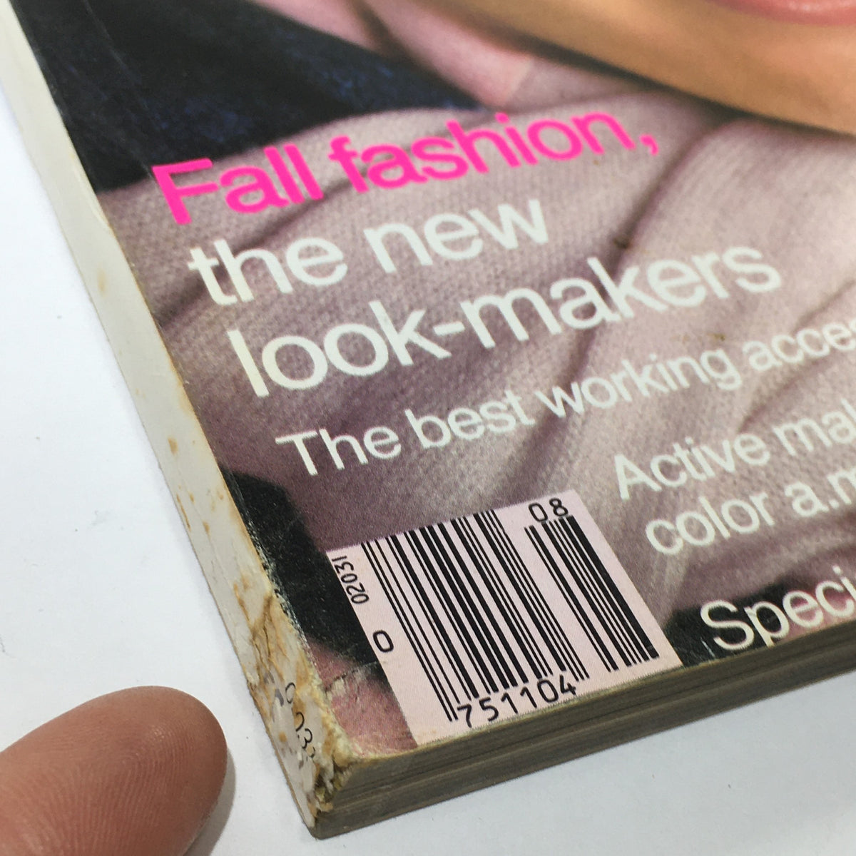 Detail of the spine and cover edge of the VTG Vogue Magazine: August 1981 - Kelly Emberg Full Cover, showcasing wear and a barcode.