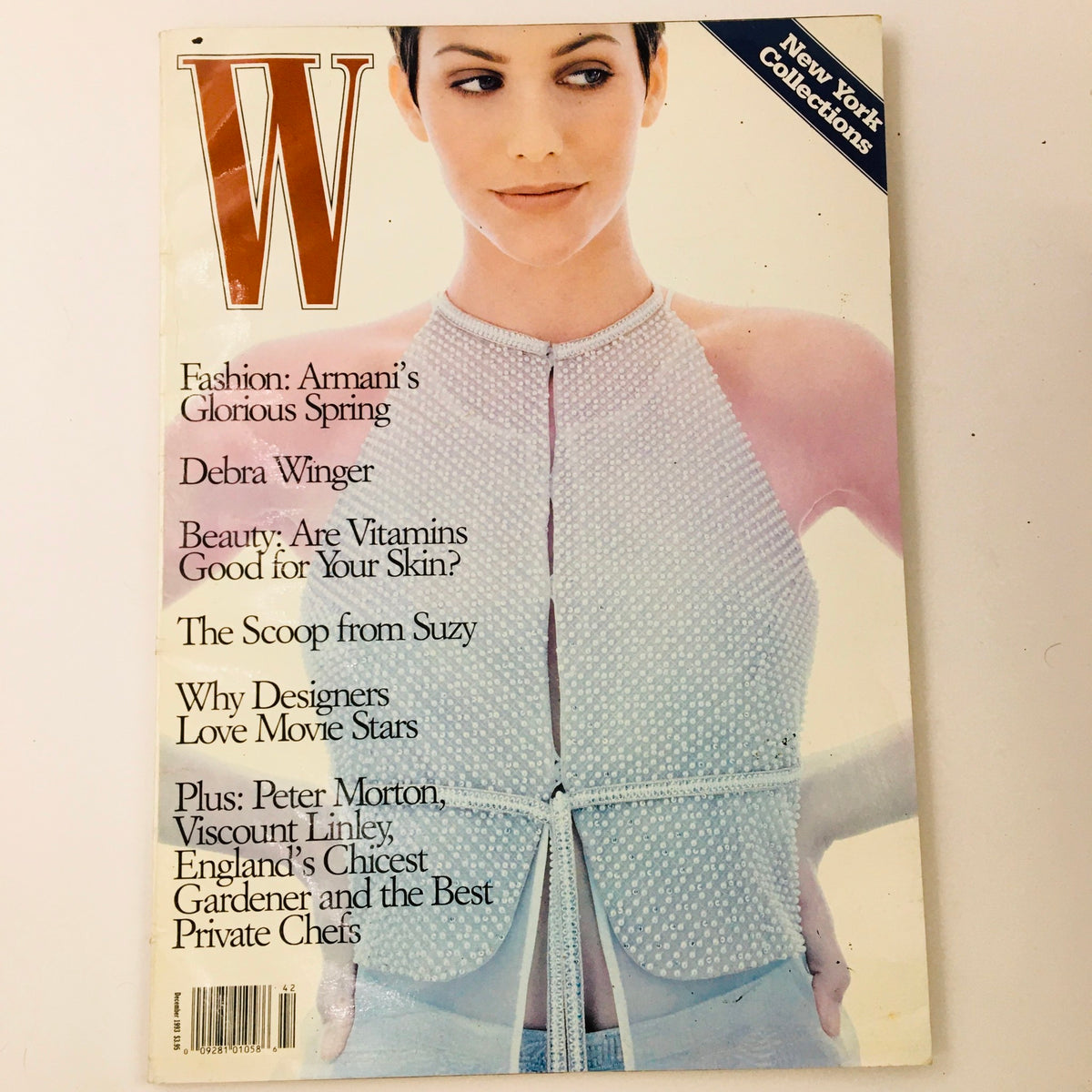 W Magazine December 1993 cover featuring actress Debra Winger in a stylish outfit, highlighting fashion topics including Armani's Spring collection and beauty advice, part of a vintage fashion collection.