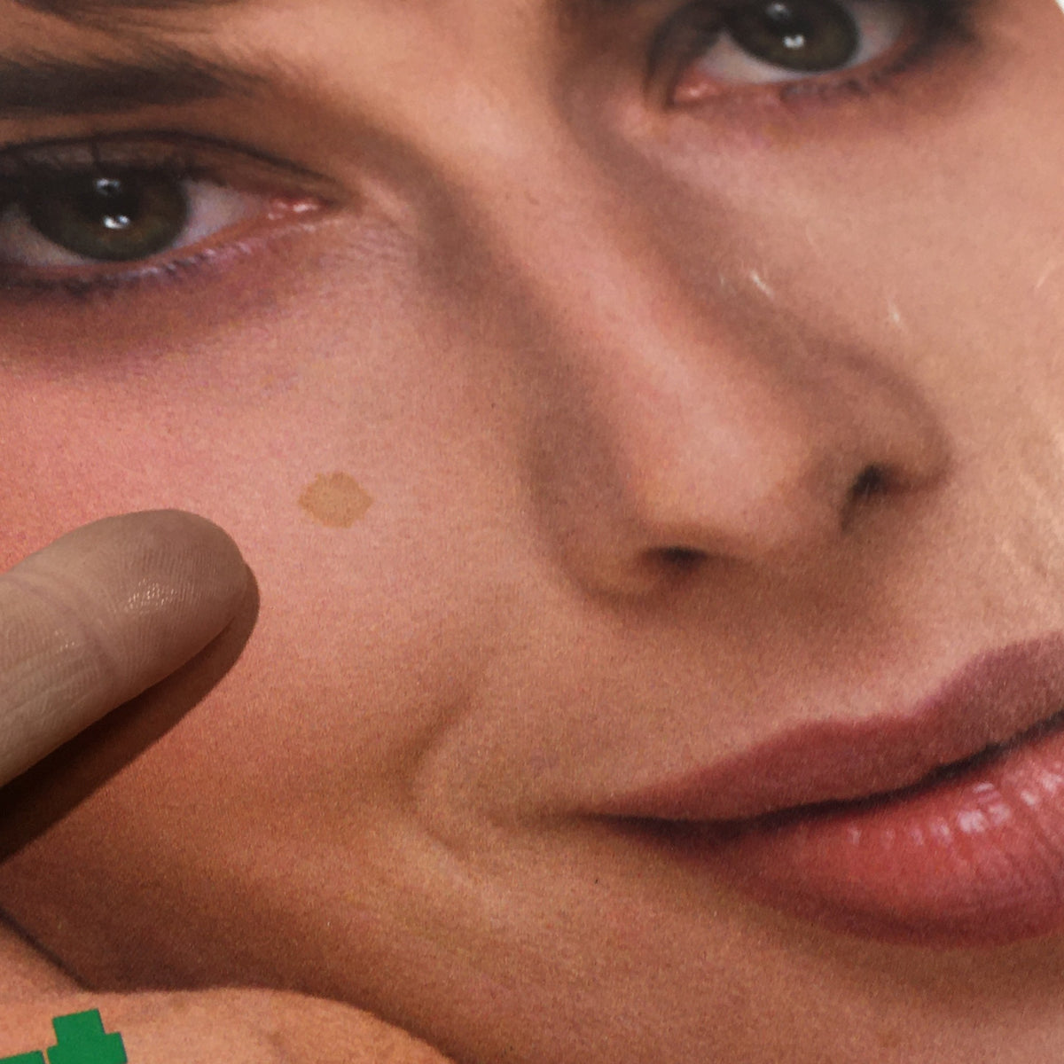 Close-up of VTG Vogue Magazine: November 1982 - Isabella Rossellini Cover featuring a beauty mark and showcasing the magazine's vintage charm.