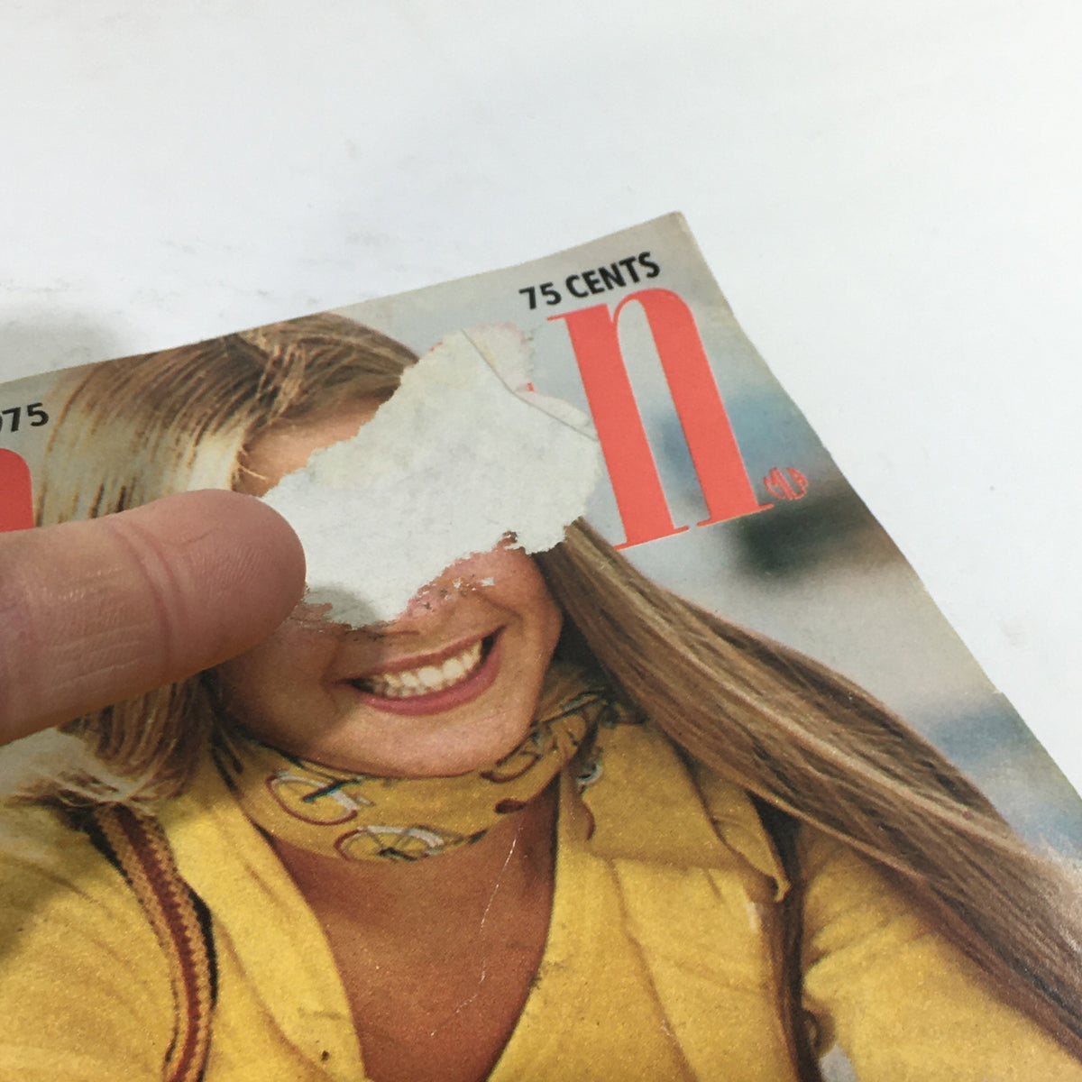 Close-up view of VTG Seventeen Magazine: May 1975 cover, illustrating a smiling young woman with a yellow scarf, and partially obscured text.