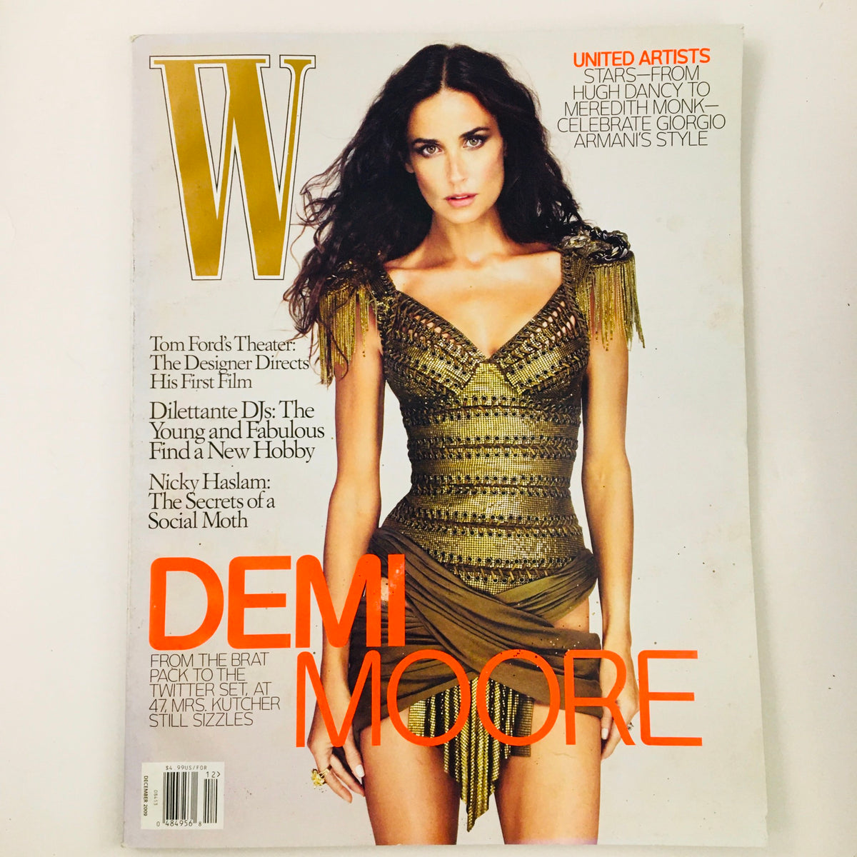 W Magazine December 2009 featuring actress Demi Moore on the cover, showcasing her in a glamorous outfit with intricate details. The issue also highlights Nicky Haslam, providing insights into fashion and celebrity culture of the time.