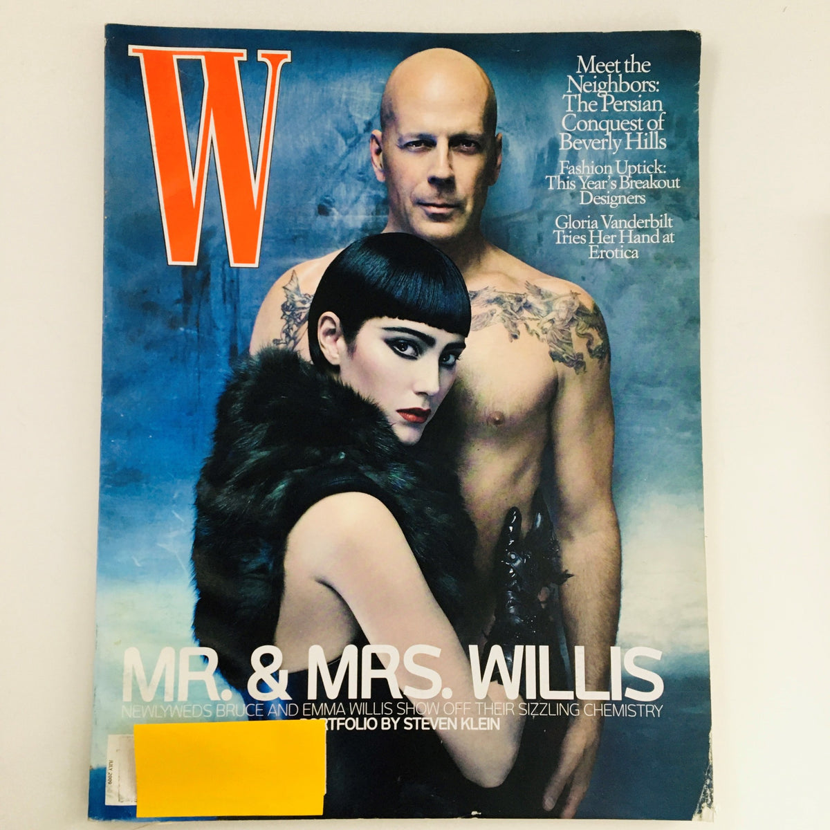 W Magazine July 2009 cover featuring Emma Heming Willis and Bruce Willis, showcasing their chemistry in a stylish portrayal for The Honeymooners issue.