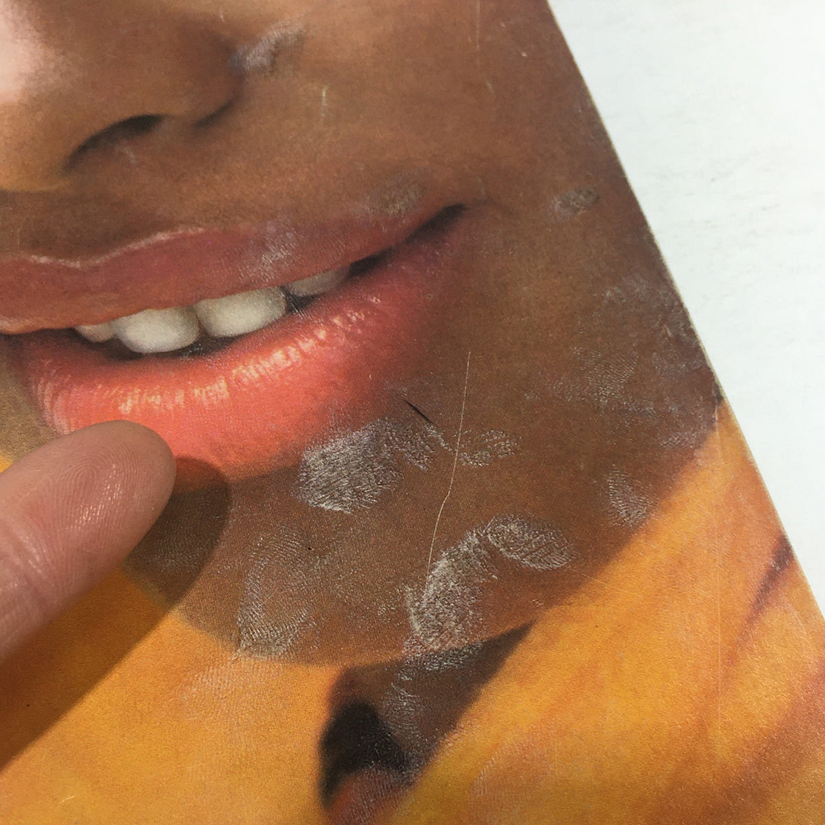 Close-up image of the cover of Essence Magazine June 1977, highlighting cosmetic details and the smile of the featured woman, encapsulating vintage beauty.