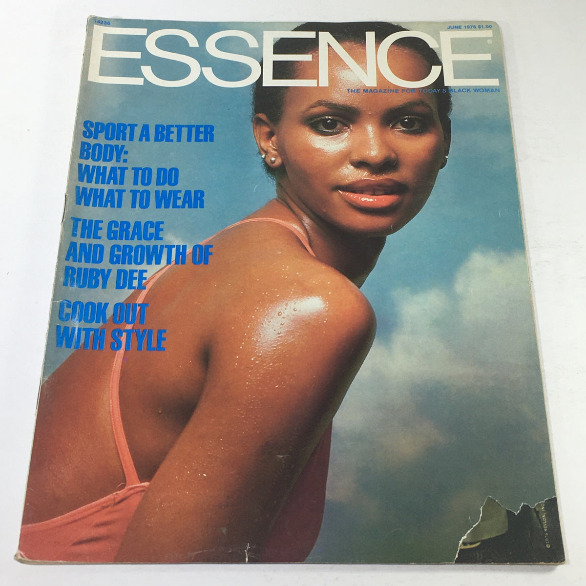 Essence Magazine June 1976 Cover featuring a model in a stylish swimsuit with bold blue text highlighting fashion and lifestyle topics. Perfect representation of 1970s fashion trends.