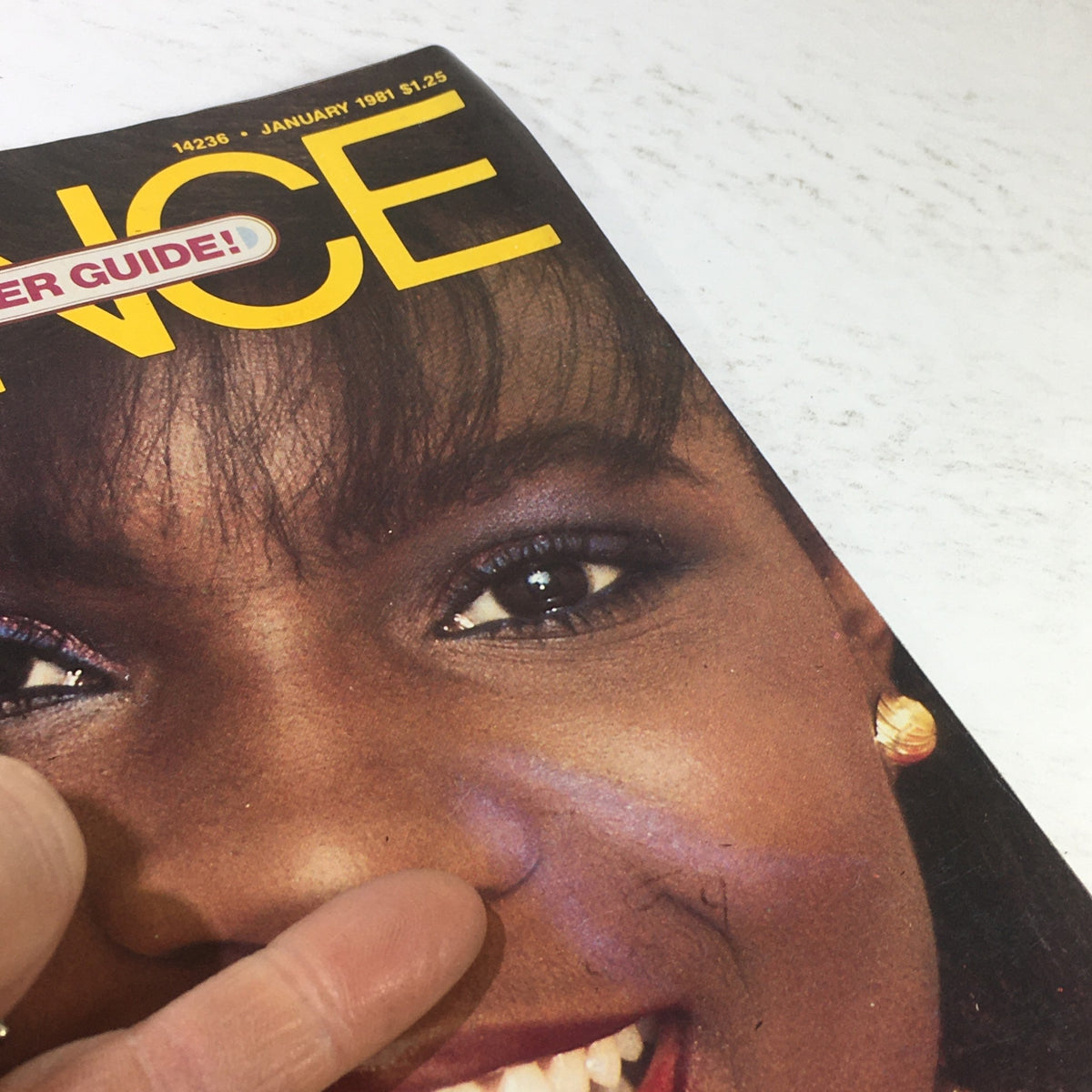 Close-up of the Essence Magazine January 1981 cover, focusing on the woman's face with detailed eye makeup and a cheerful expression, emphasizing beauty features.