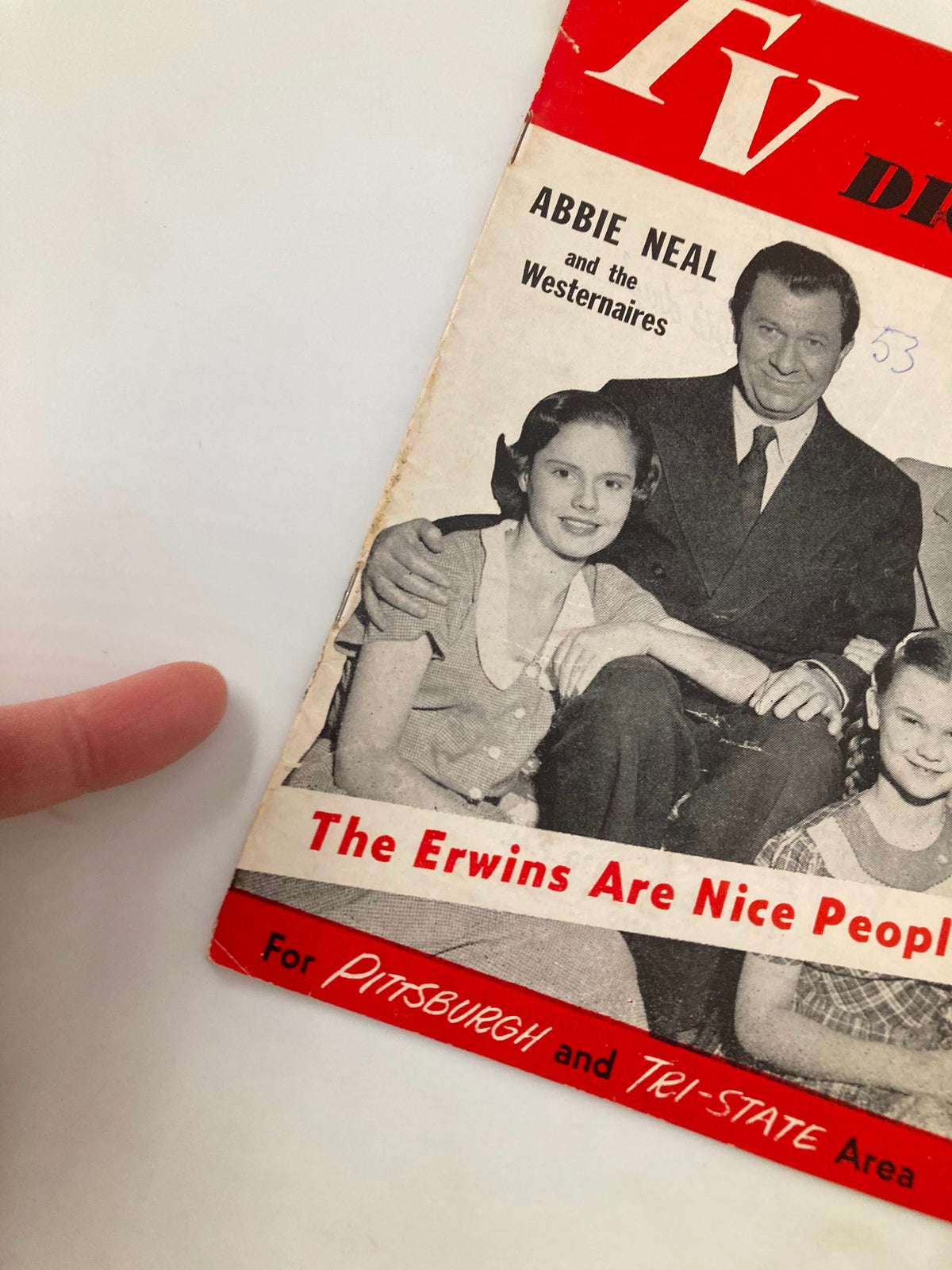 Close-up of TV Digest Magazine January 24, 1953 featuring Abbie Neal on the cover, titled 'The Erwins Are Nice People', showing a portion of the magazine with a finger pointing to the cover.