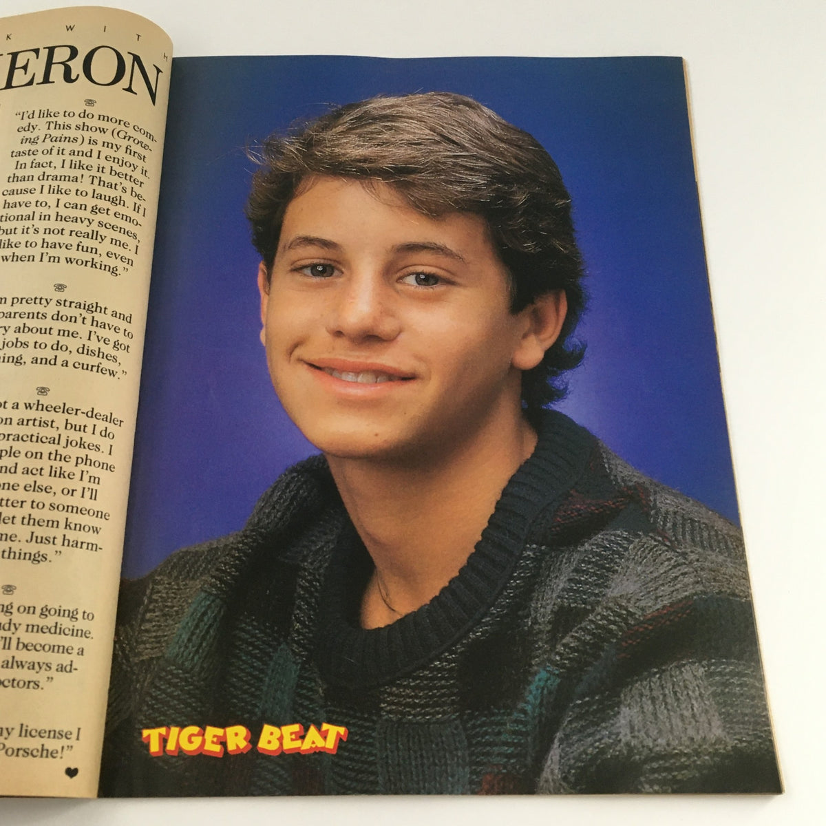 A portrait of a young actor from Tiger Beat Magazine December 1986, exuding 80s charm with a casual look.