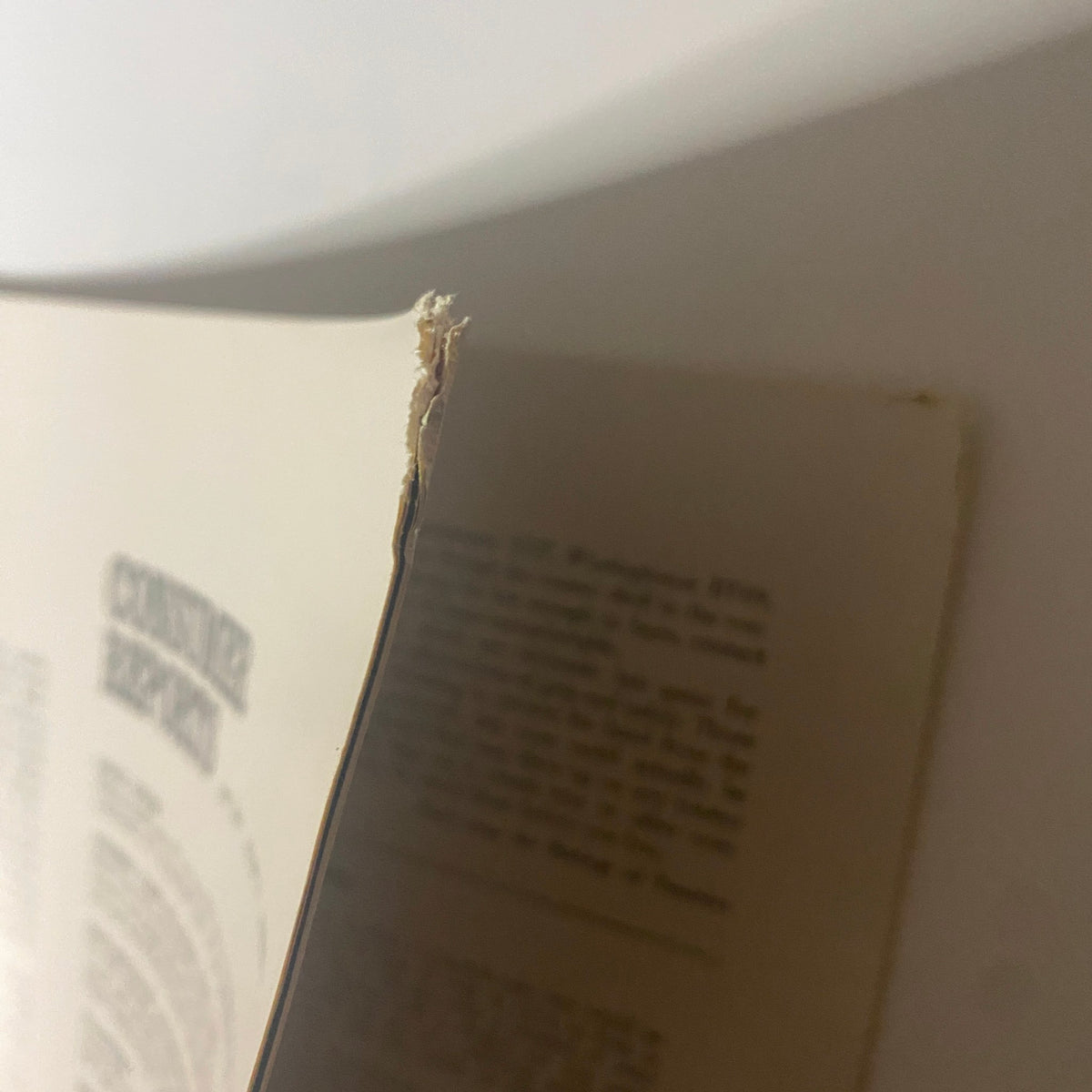 Close-up of the spine of Consumer Reports Magazine May 1966 showing minor wear and tear, indicating its vintage nature.