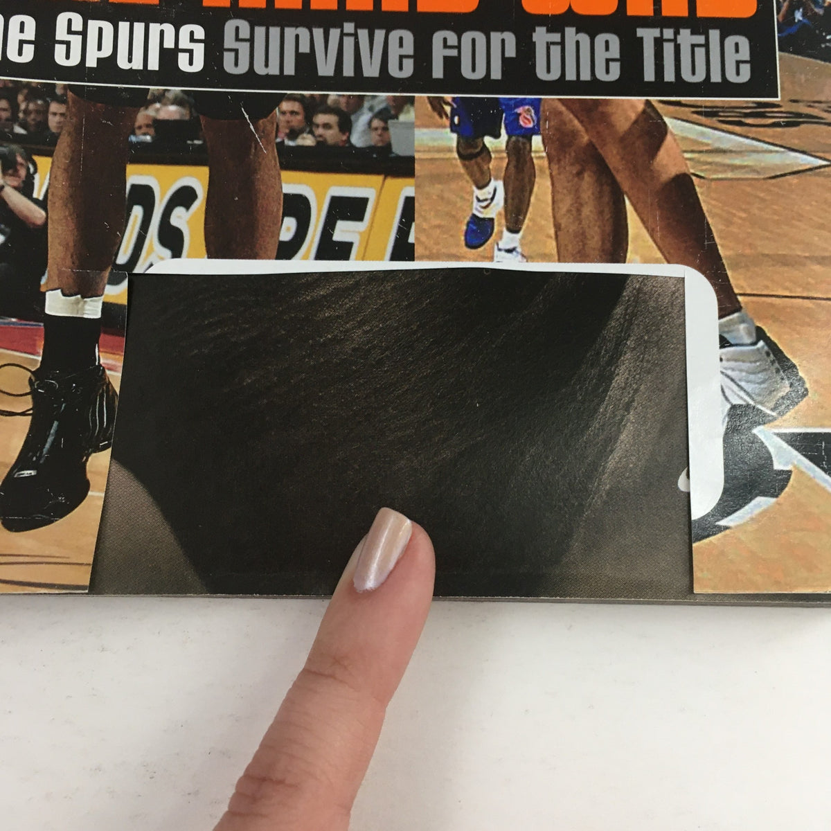 Close-up detail of the Slam Magazine September 2005 featuring Manu Ginóbili, Horry & Tim Duncan, highlighting the magazine's protective covering and minor wear conditions.