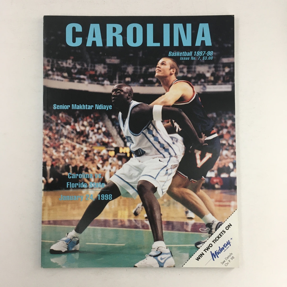 Carolina Basketball 1997-1998 Senior Makhtar Ndiaye Feature magazine cover with Makhtar Ndiaye playing against a Virginia player during a college basketball game on January 24, 1998.