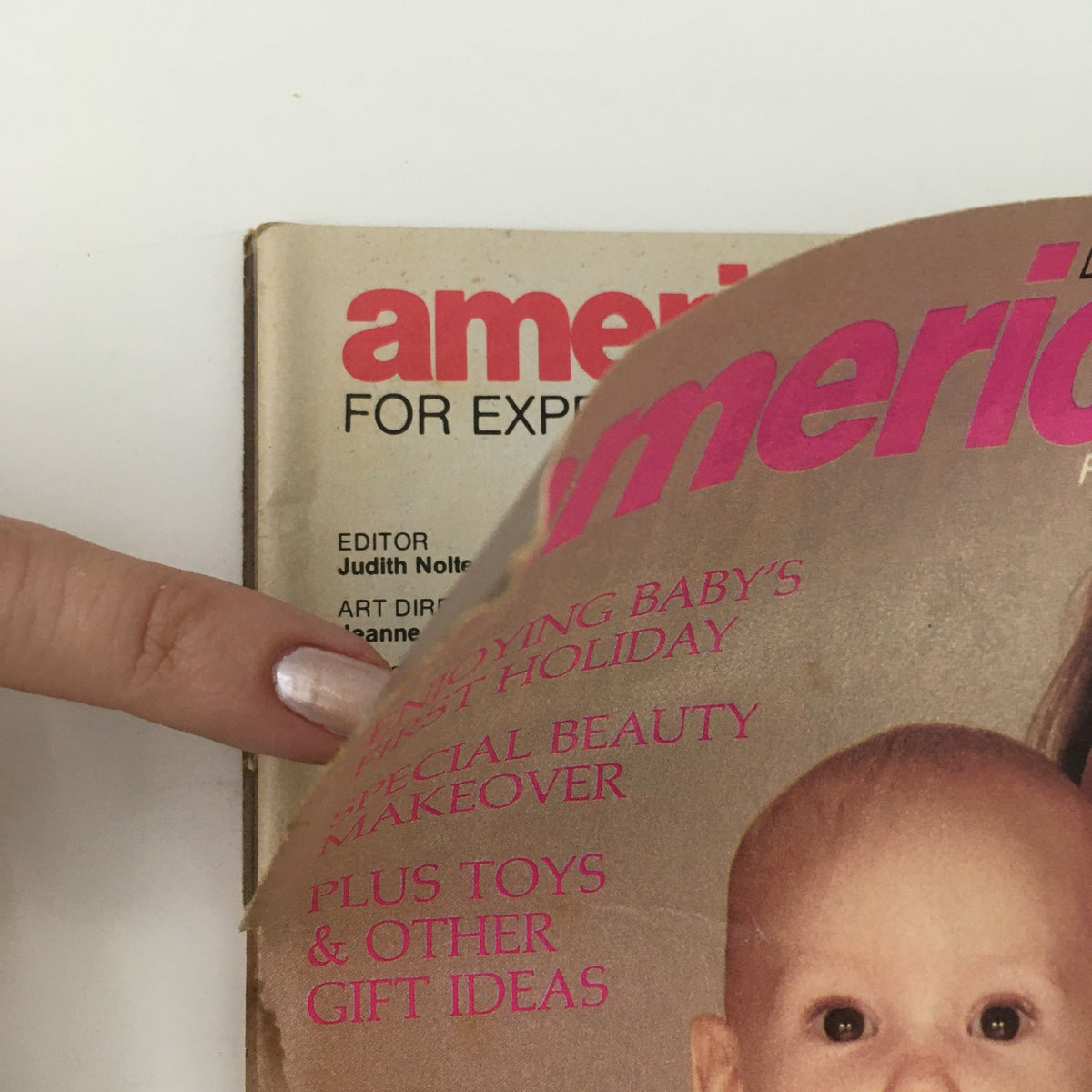 Close-up of American Baby Magazine December 1980 showing text about enjoying baby's first holiday, special beauty makeover, and more gift ideas.