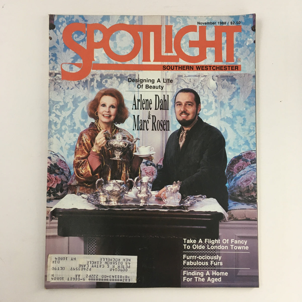 Spotlight Magazine from November 1988 featuring Arlene Dahl and Marc Rosen on the cover, showcasing a glamorous life filled with beauty. The magazine highlights artistry with elegant decor and silverware on display.