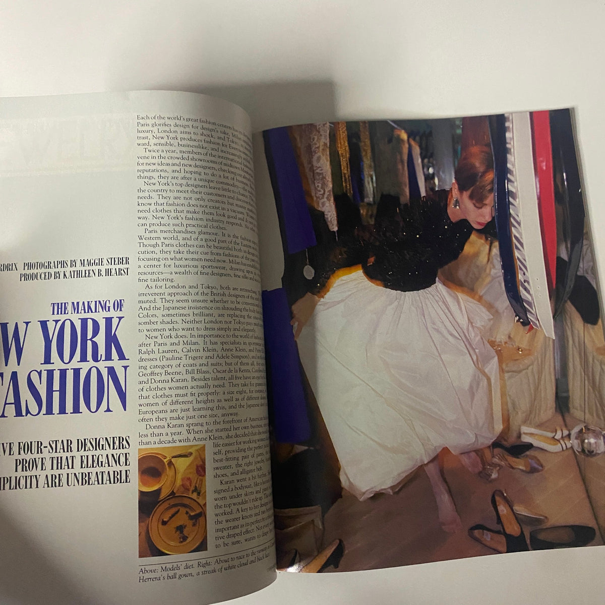 Editorial page from Connoisseur Magazine February 1986 titled 'The Making of New York Fashion,' featuring a photograph of a designer amidst garments in a fashion studio.