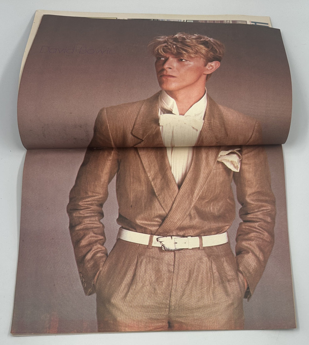 David Bowie featured in Hit Parader Magazine April 1983, showcasing his iconic style in a fashionable suit.
