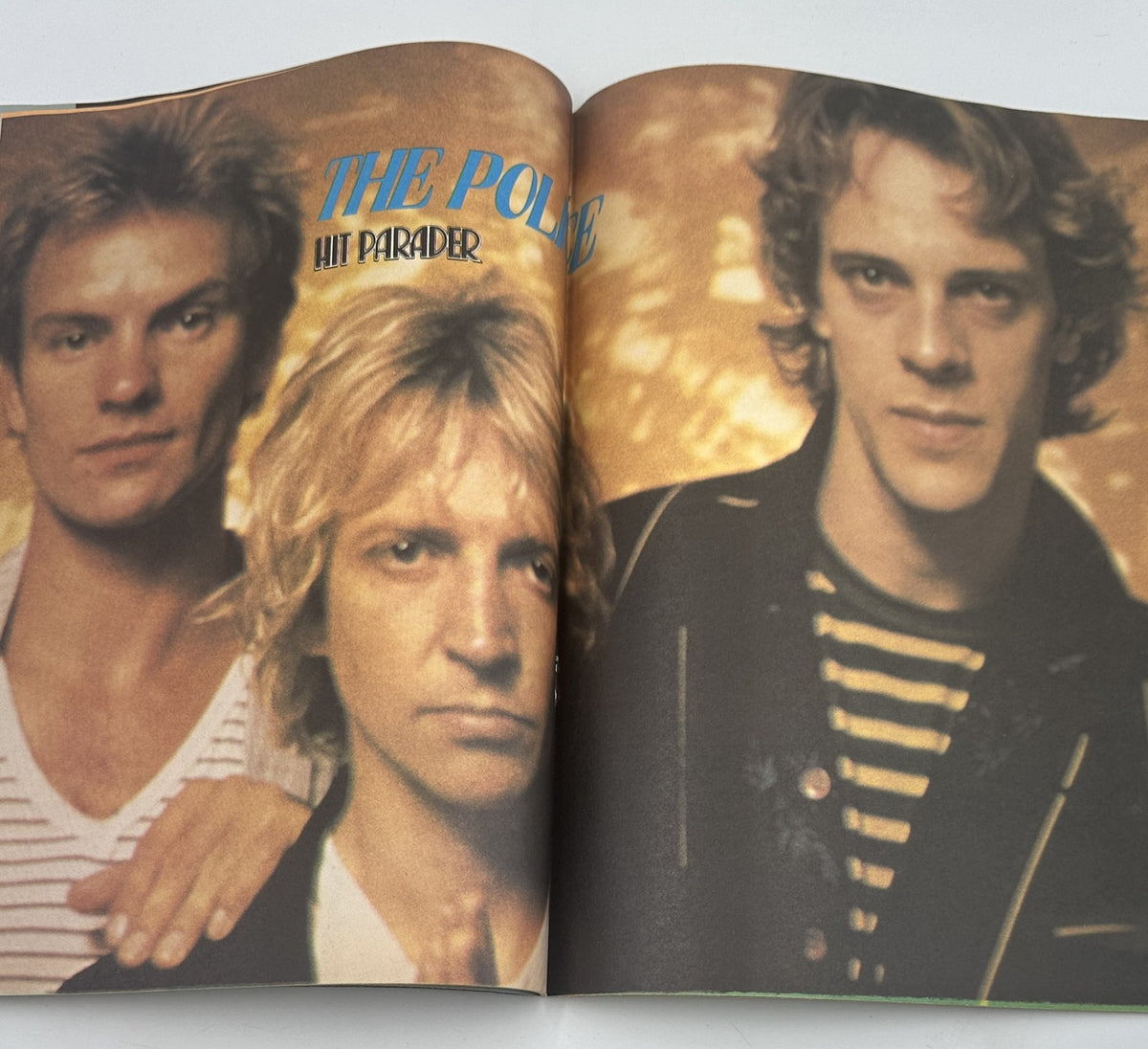 Centerfold image from Hit Parader Yearbook Magazine 1981 featuring The Police, with a striking visual of band members Sting, Stewart Copeland, and Andy Summer.