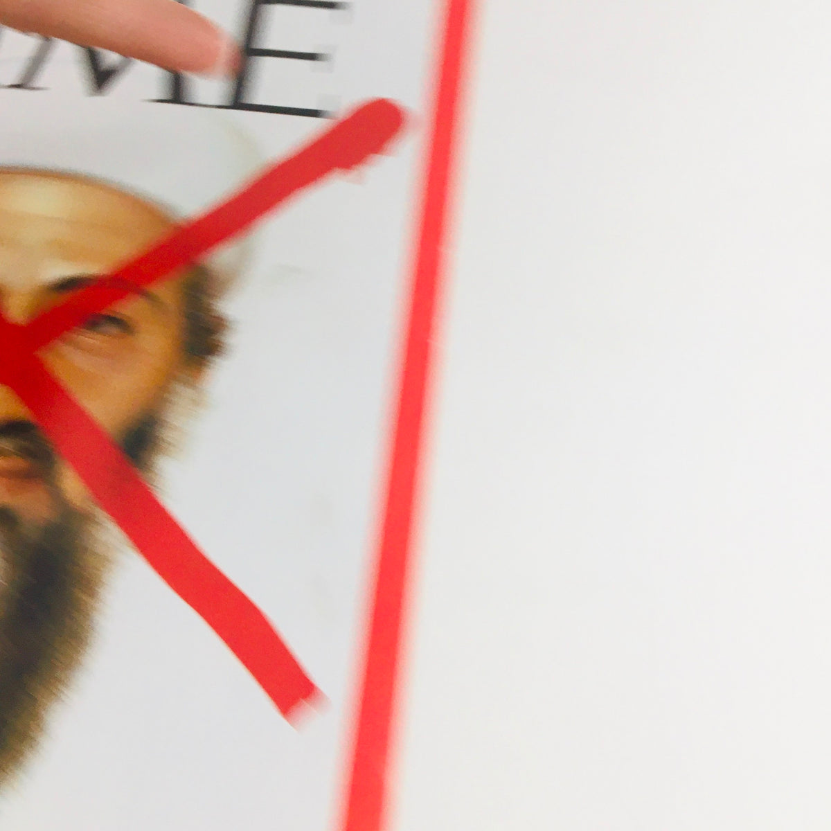 Close-up of the Time Magazine cover from May 20, 2011, showing a red 'X' over Osama Bin Laden's face, part of the article 'The End of Osama Bin Laden'.