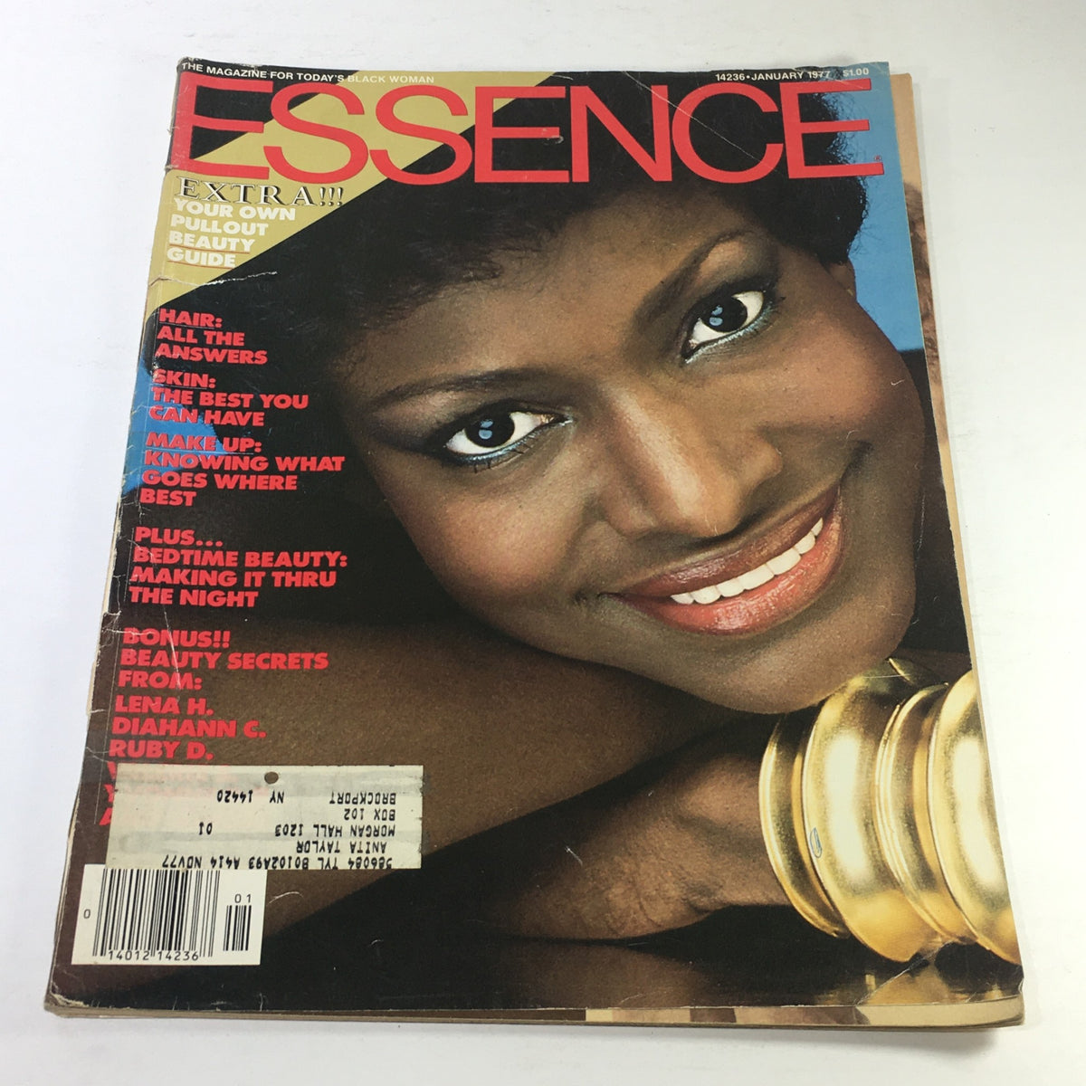 Essence Magazine January 1977 Cover featuring a radiant model with striking makeup and jewelry, showcasing the beauty and culture of African American women.