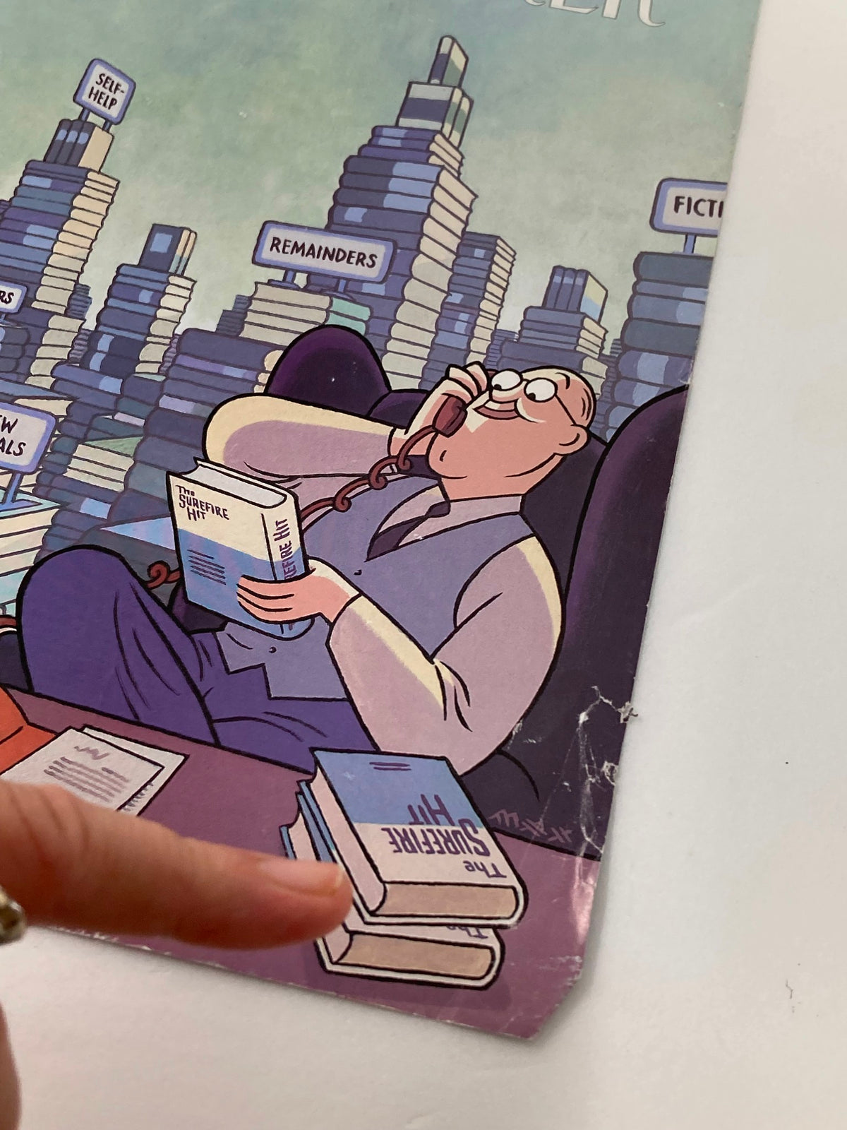 COVER ONLY The New Yorker October 6, 1997 Tall Stories by Max capturing a close-up of the magazine cover, showcasing the character reading a book with a visible crease on the edge, amid a backdrop of literary-themed stacks of books.