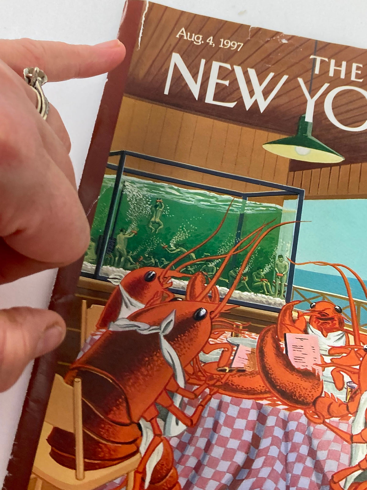 Close-up of The New Yorker cover from August 4, 1997, titled 'Lobsterman's Special' by Bruce McCall, highlighting lobsters at a table with a fish tank in the background.