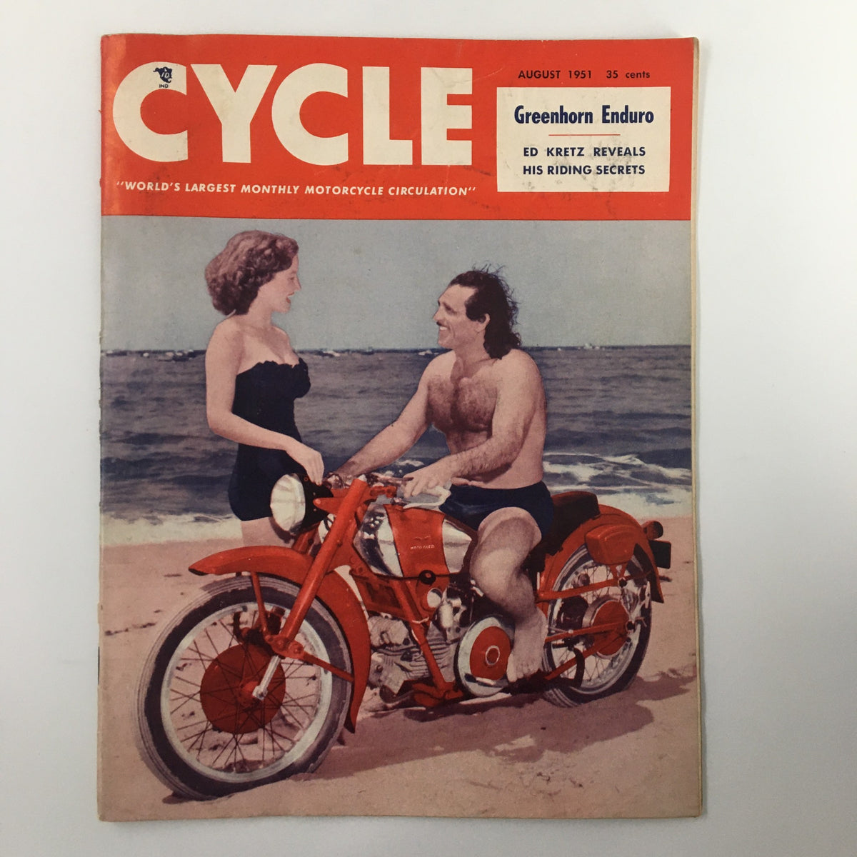 Cover of VTG Cycle Magazine August 1951 featuring Baron Michele Leone Jr. along with a woman on a motorcycle at the beach, highlighting vintage sports culture.