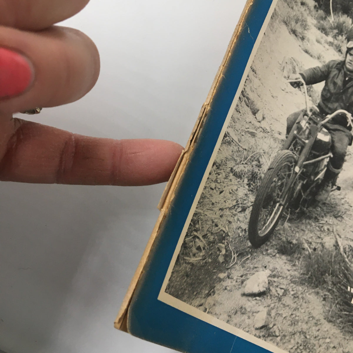 Close-up of the vintage cycle magazine February 1953, showing a motorcycle rider on a dirt path, part of the VTG Cycle Magazine featuring 'The Rams Go Wild'.