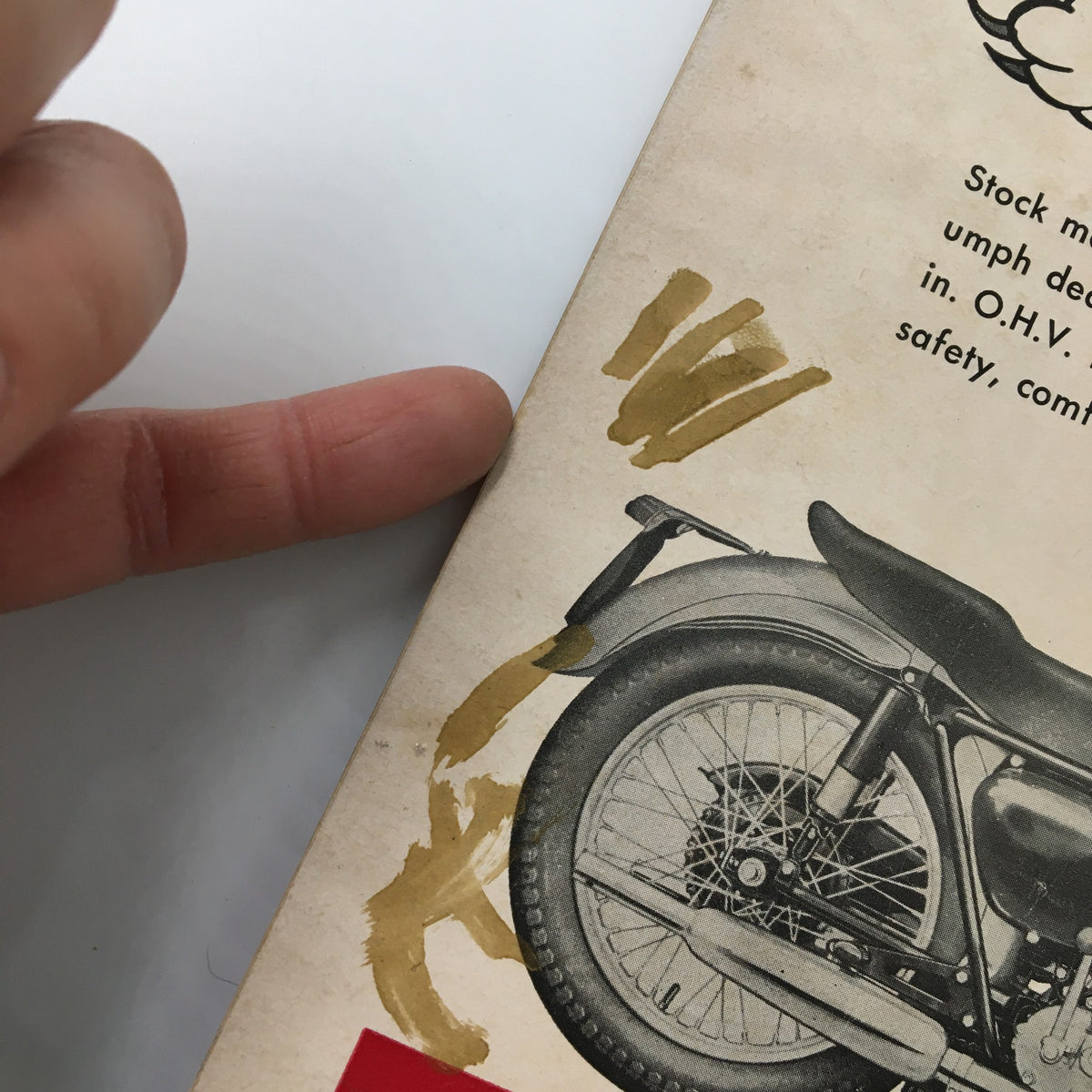 Detail of the back cover of VTG Cycle Magazine June 1954 highlighting a motorcycle image with wear marks, indicative of its vintage condition.