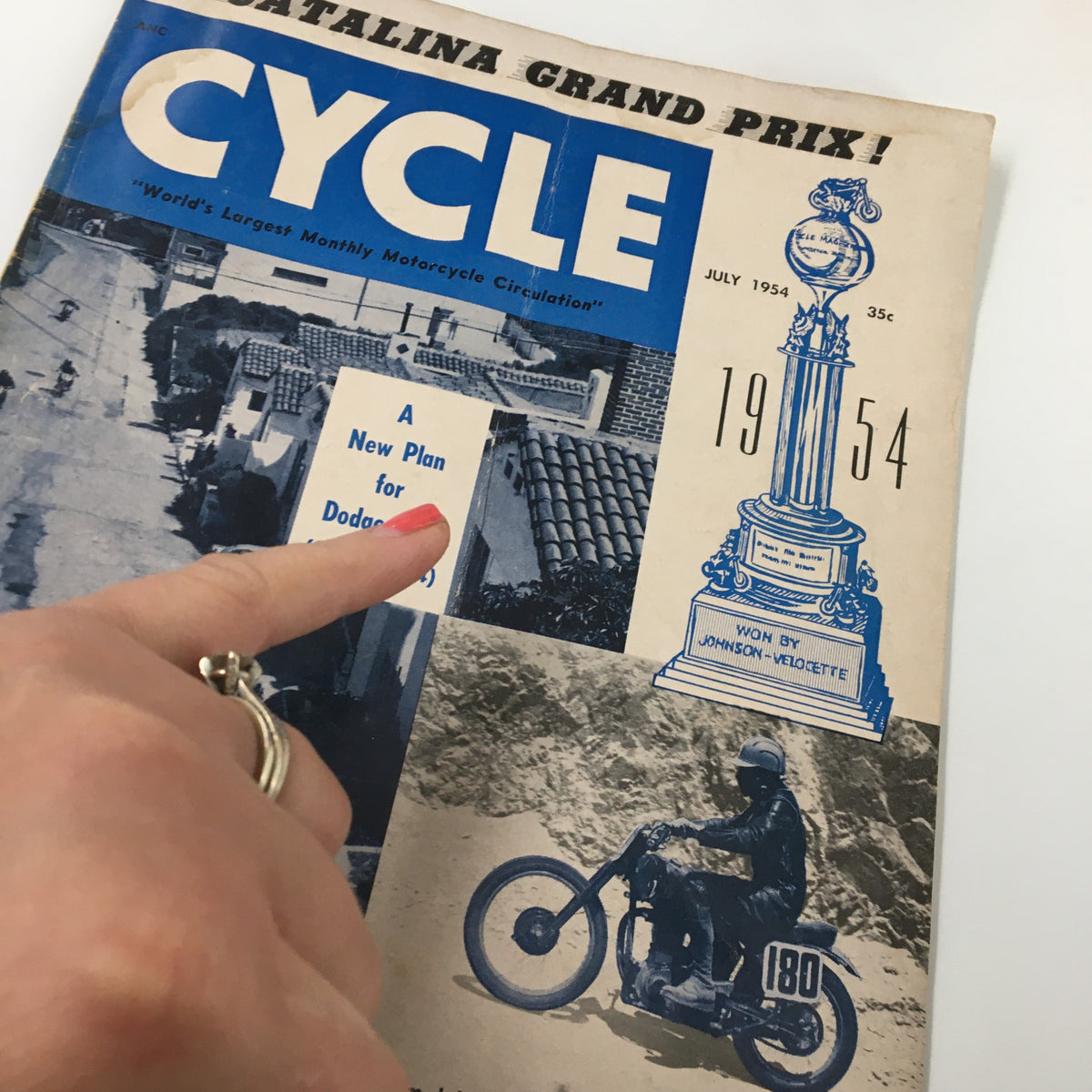 Detailed view of VTG Cycle Magazine July 1954 cover, highlighting the road test for The 'Catalina' Velo and text discussing a new plan for Dodge City.