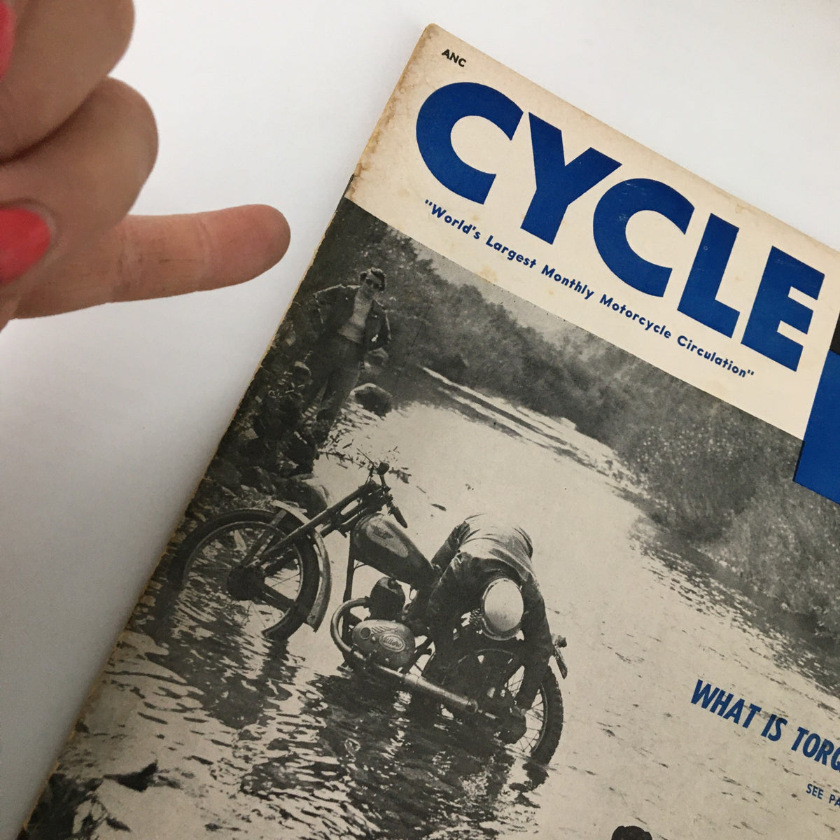 Close-up of the cover of VTG Cycle Magazine February 1955 highlighting a motorcycle in water and the articles 'Covered Wagon Enduro' and 'What is Torque?'.