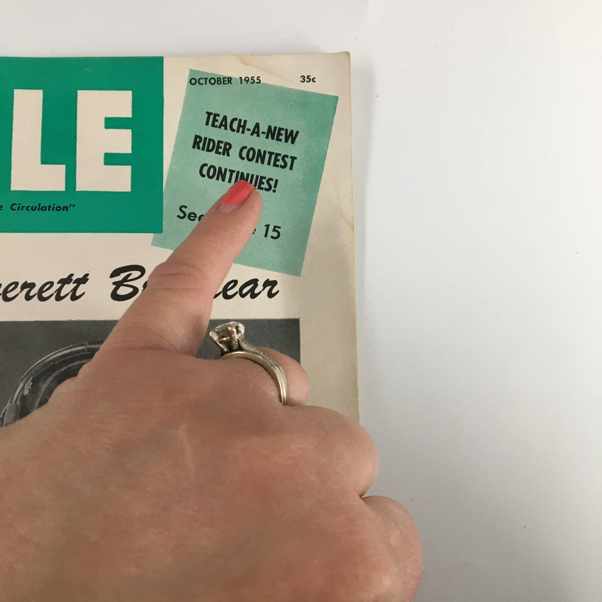 Cover of the VTG Cycle Magazine October 1955 featuring a hand pointing to an ad for a rider contest. Highlights the magazine's vintage appeal and relates to Everett Brashear, AMA Points 1st Place.
