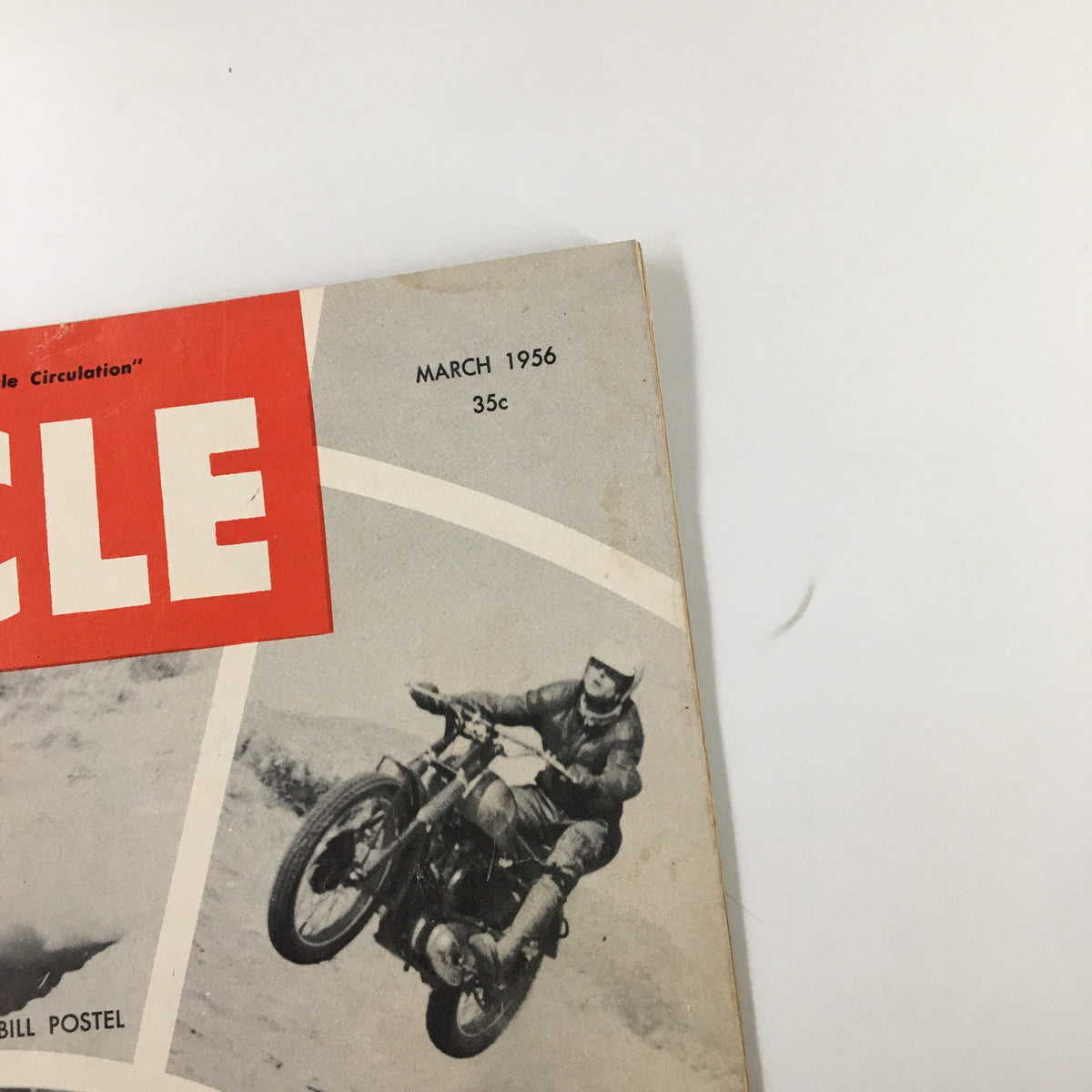 Close-up view of the VTG Cycle Magazine March 1956 cover featuring the title 'CYCLE', the date, and the price, along with a racing motorcycle image.