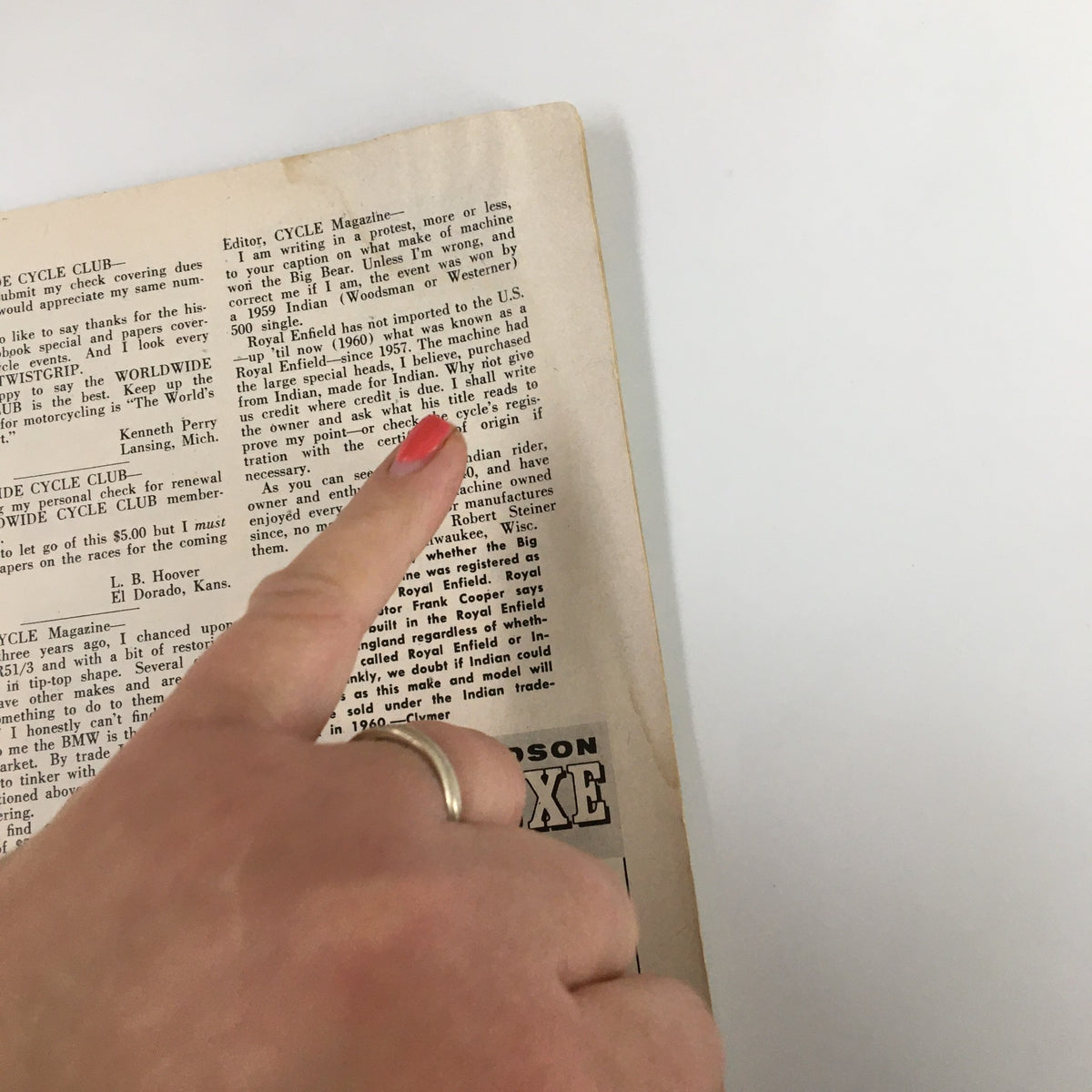 Inside page of VTG Cycle Magazine May 1960 showing text and the author's finger pointing, highlighting content related to motorcycle history.