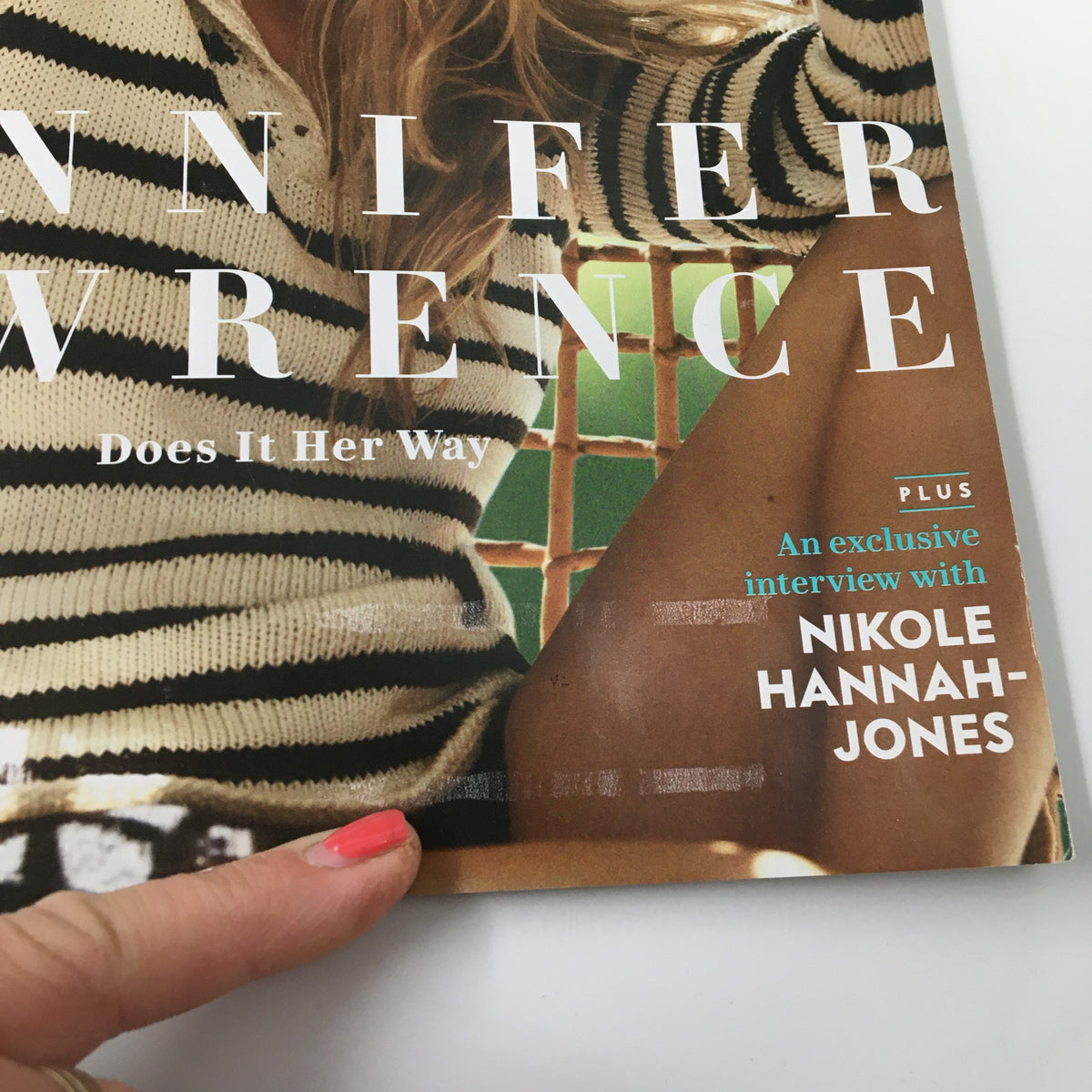 Close-up detail of Vanity Fair Magazine December 2021 cover with actress Jennifer Lawrence. The text highlights an exclusive interview with Nikole Hannah-Jones, emphasizing the magazine's cultural relevance and insights.