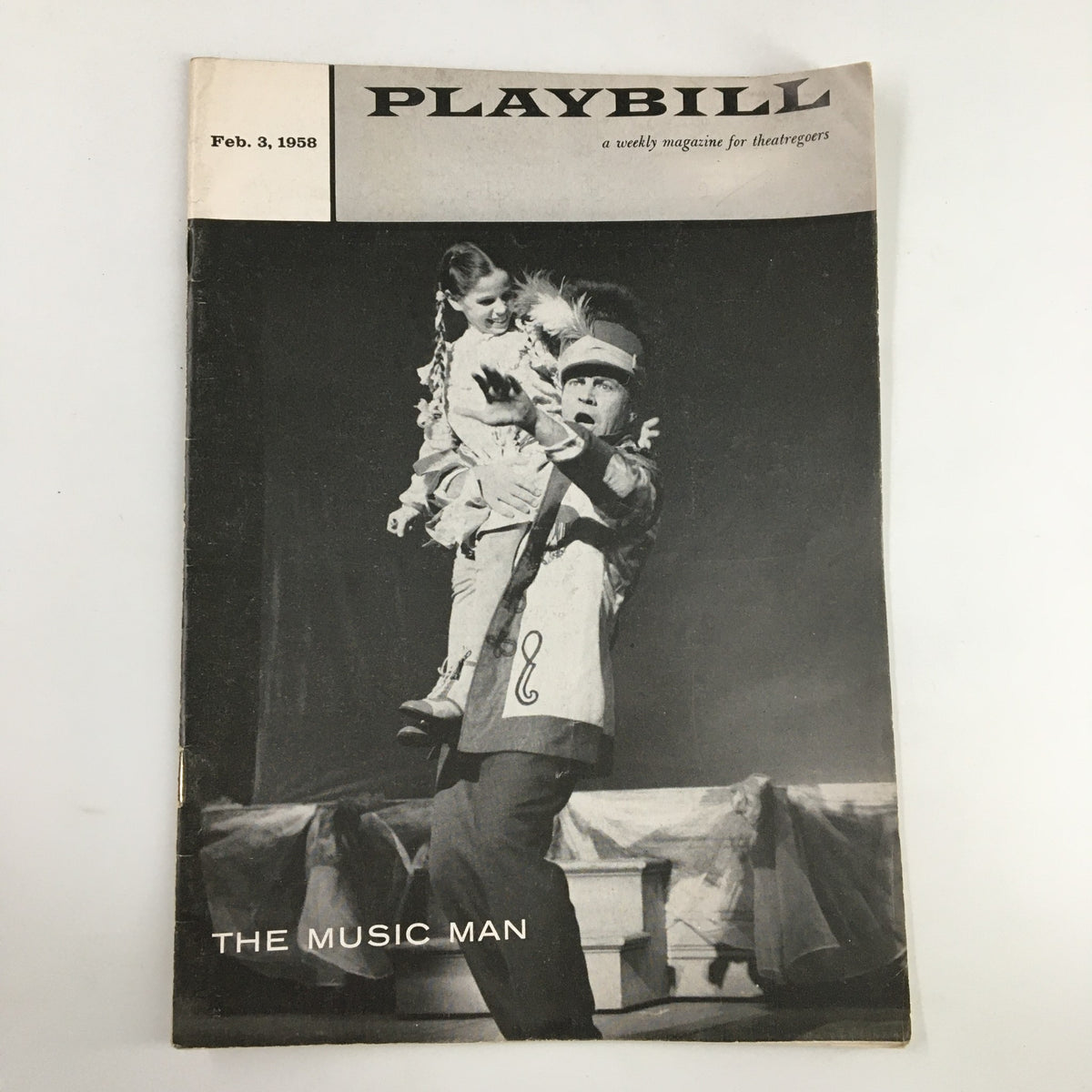 1958 Playbill for The Music Man featuring Robert Preston, showcasing a performance scene with a man in costume and a girl on his shoulders.