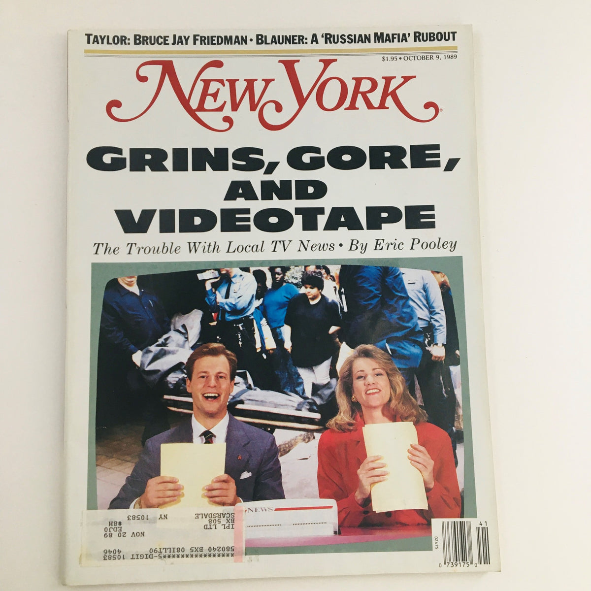 Cover of New York Magazine from October 9, 1989, featuring the title 'Grins, Gore, and Videotape' by Eric Pooley, showcasing two smiling news anchors in front of a vibrant crowd.