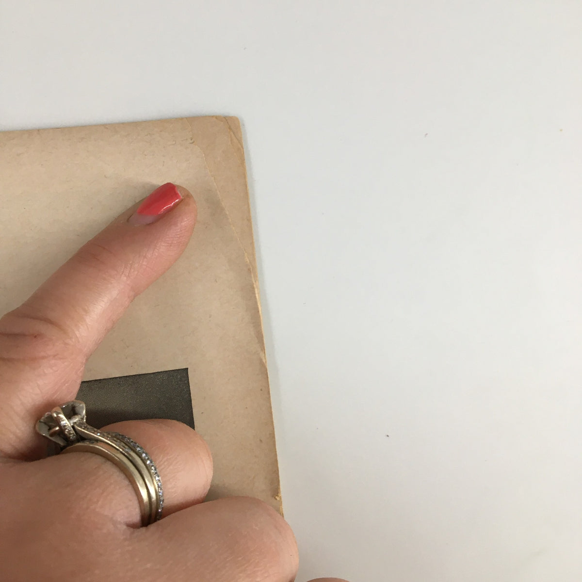 Close-up image showing the edge of a 1951 Playbill for The Music Box, highlighting minor wear and a finger holding the page, indicative of its vintage quality.