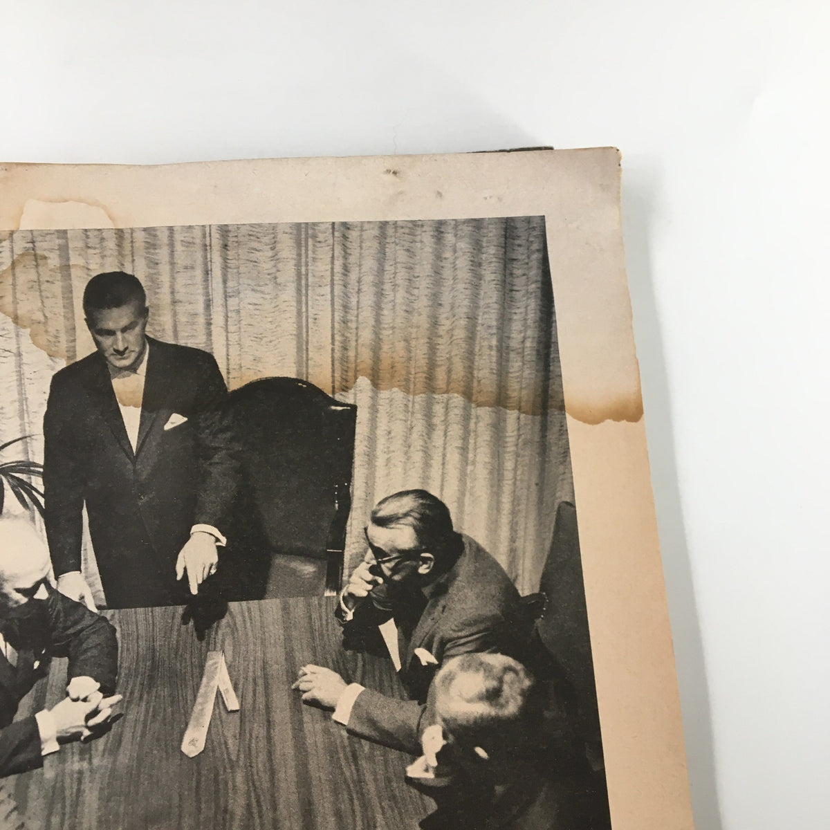 Black and white photo of a formal meeting with men in tuxedos, highlighting a classic fashion era, from The New Yorker Magazine September 26, 1964.